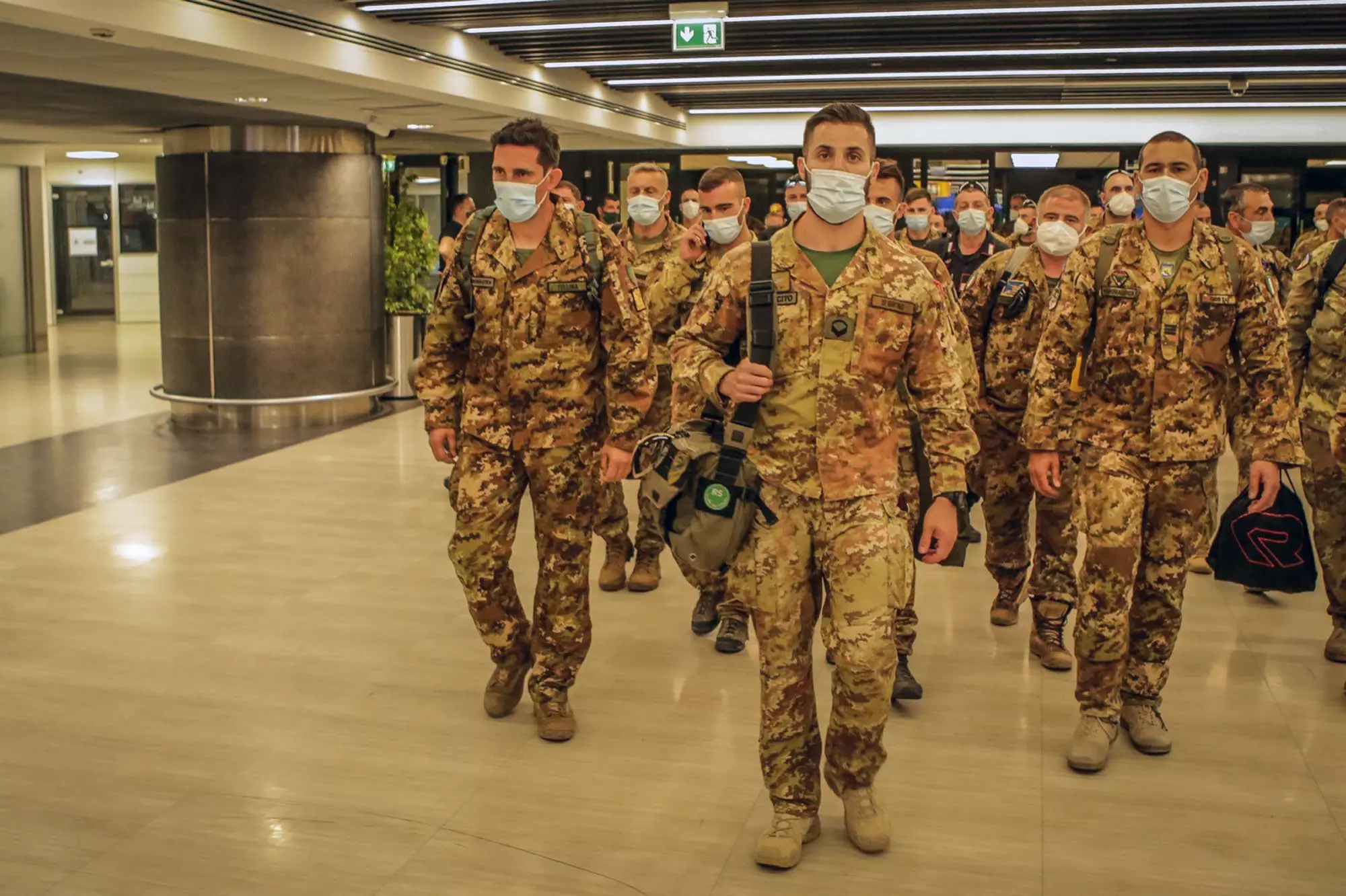 The last Italian troops withdrawing from Afghanistan walk through the airport.