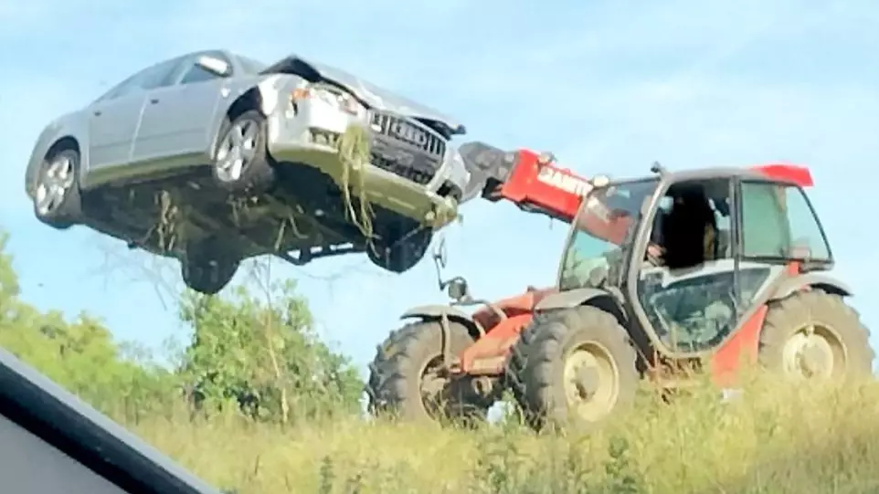 Farmer Removes Abandoned Audi From His Field With His Own Vehicle