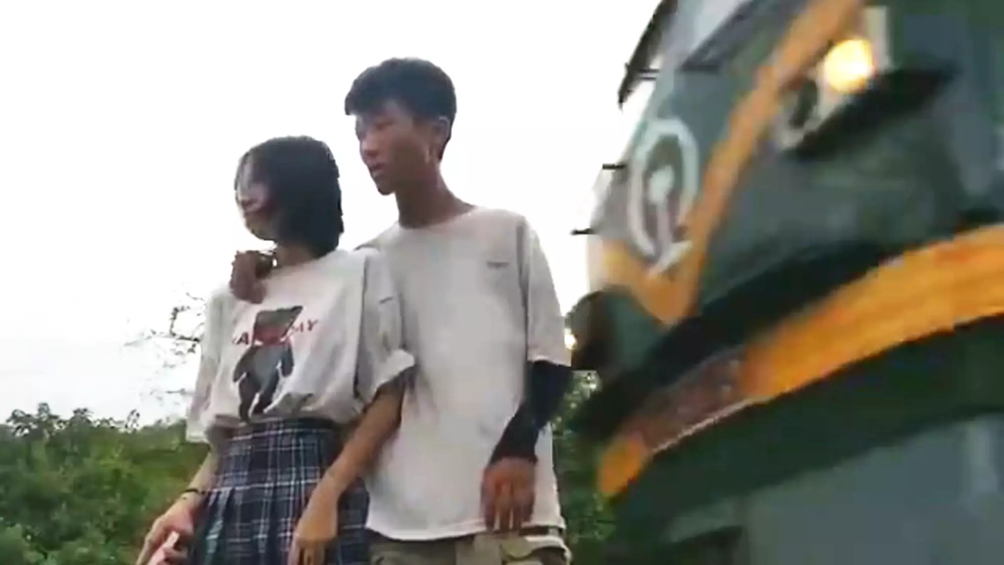 Chinese Couple Narrowly Avoid Freight Train While Filming For Social Media