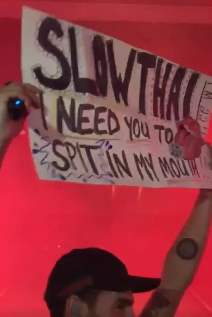 Slowthai brandishing the fan's sign, which outlined her request.