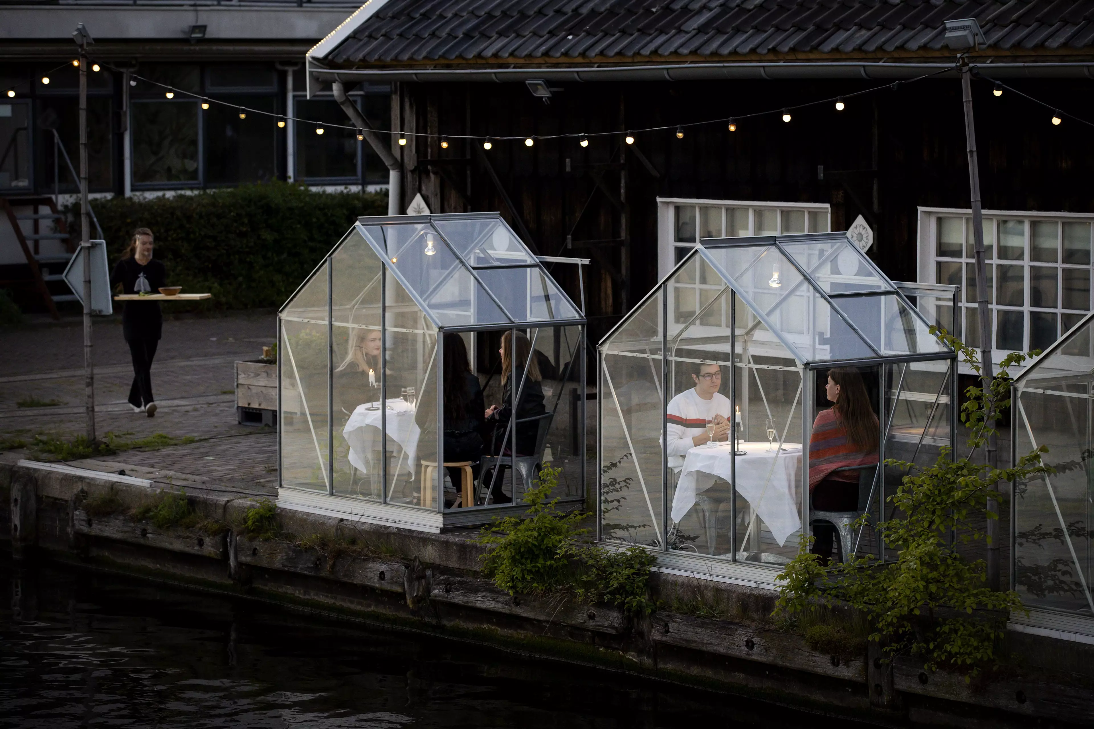 A restaurant in Amsterdam has installed greenhouses for diners.