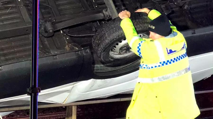 Police Officer Holds Car With His Bare Hands To Stop It Falling Off Motorway
