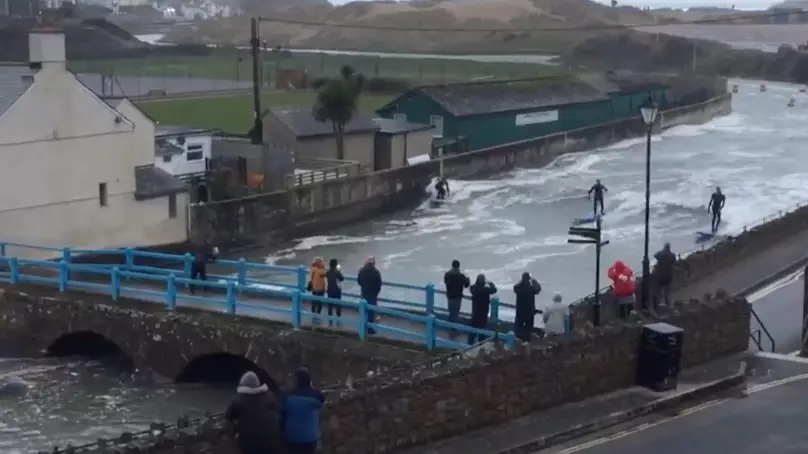 Video Shows Three Surfers Riding Wave Under Bridge In Cornwall