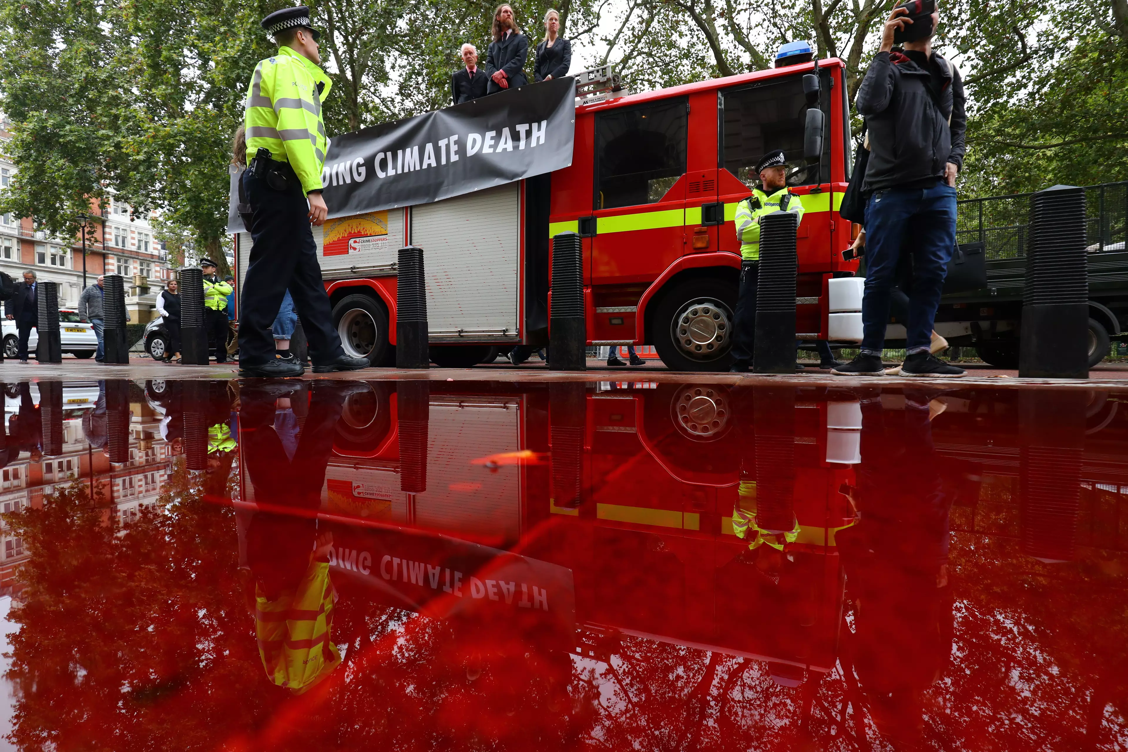 Extinction Rebellion protesters sprayed 1,800 litres of fake blood from a fire engine.