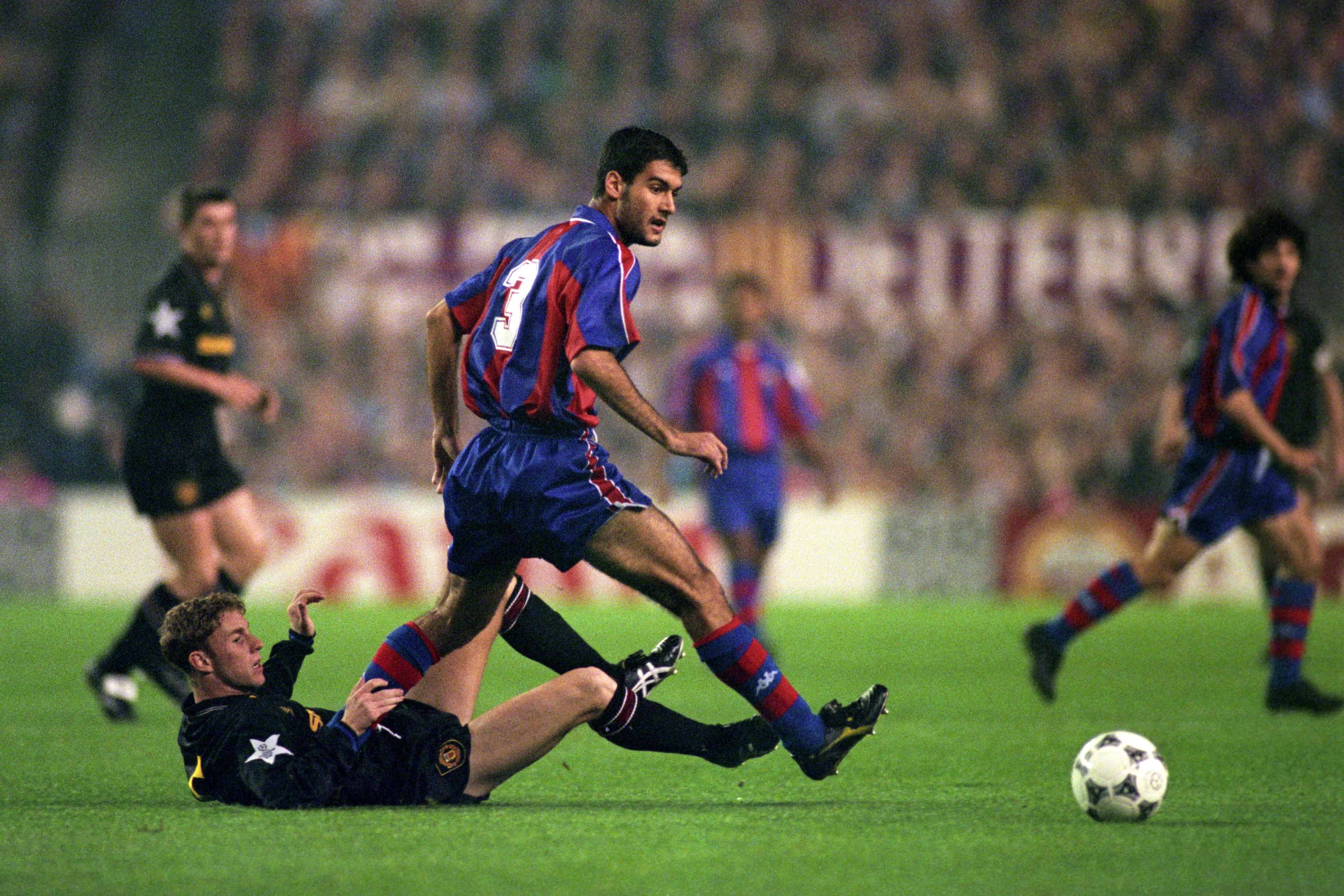 Nicky Butt and Pep Guardiola tangle during a 4-0 win to Barcelona. Image: PA Images