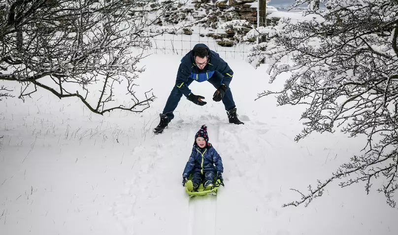 Kids make the most of the drifting snow on the Cotswold hills, Worcestershire.