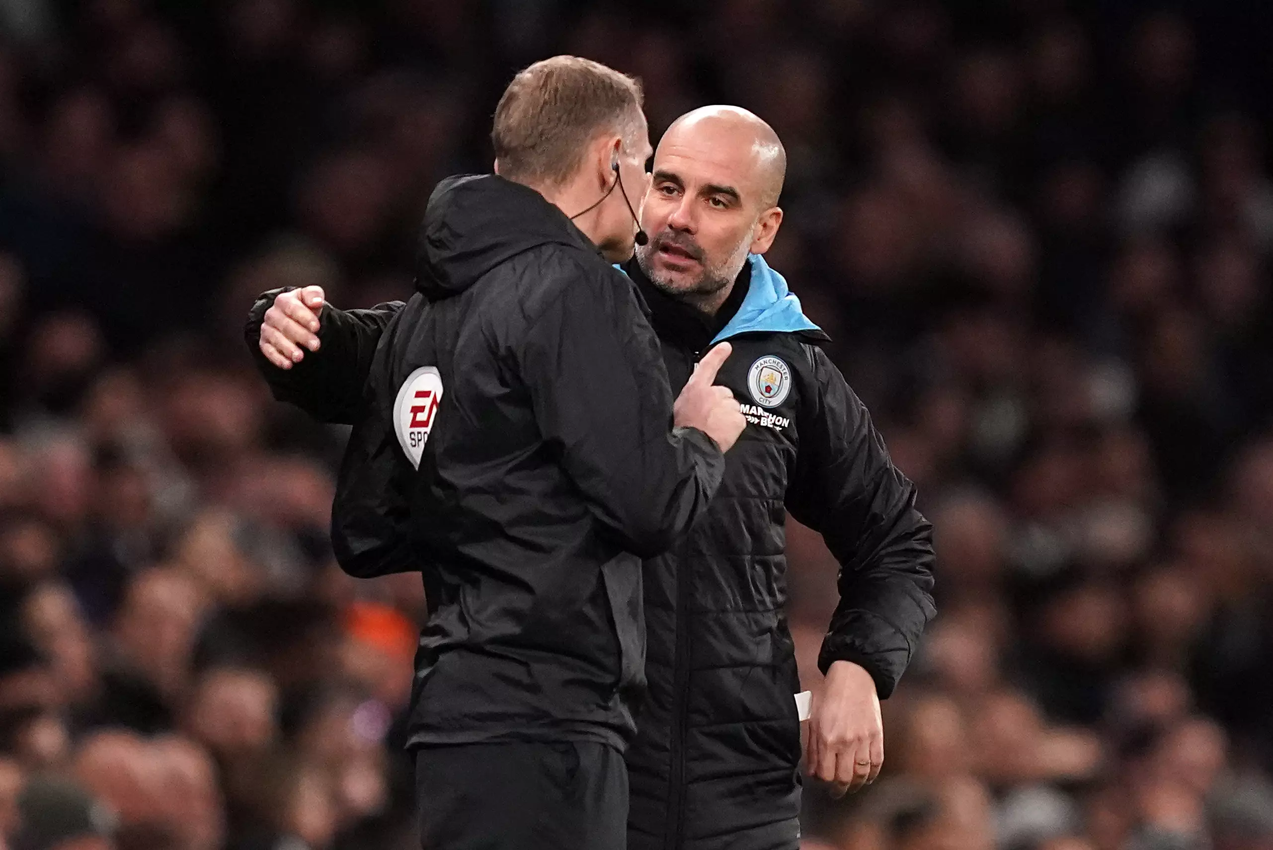 Guardiola discusses a referee decision with the fourth official. Image: PA Images