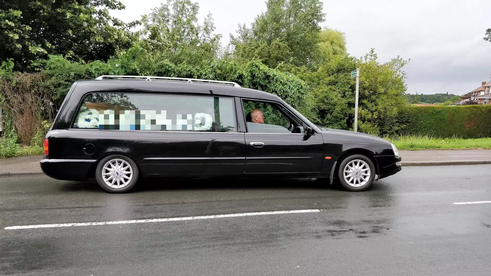 Man's Coffin Accompanied In Hearse By 'B*****d' Floral Tribute 