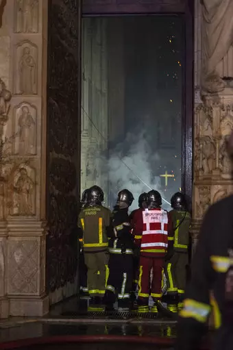 Firefighters work to put out Notre Dame blaze.