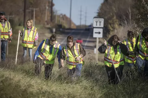 A group of volunteers search the ditches along Highway 8, near the home where 13-year-old Jayme Closs lived with her parents.