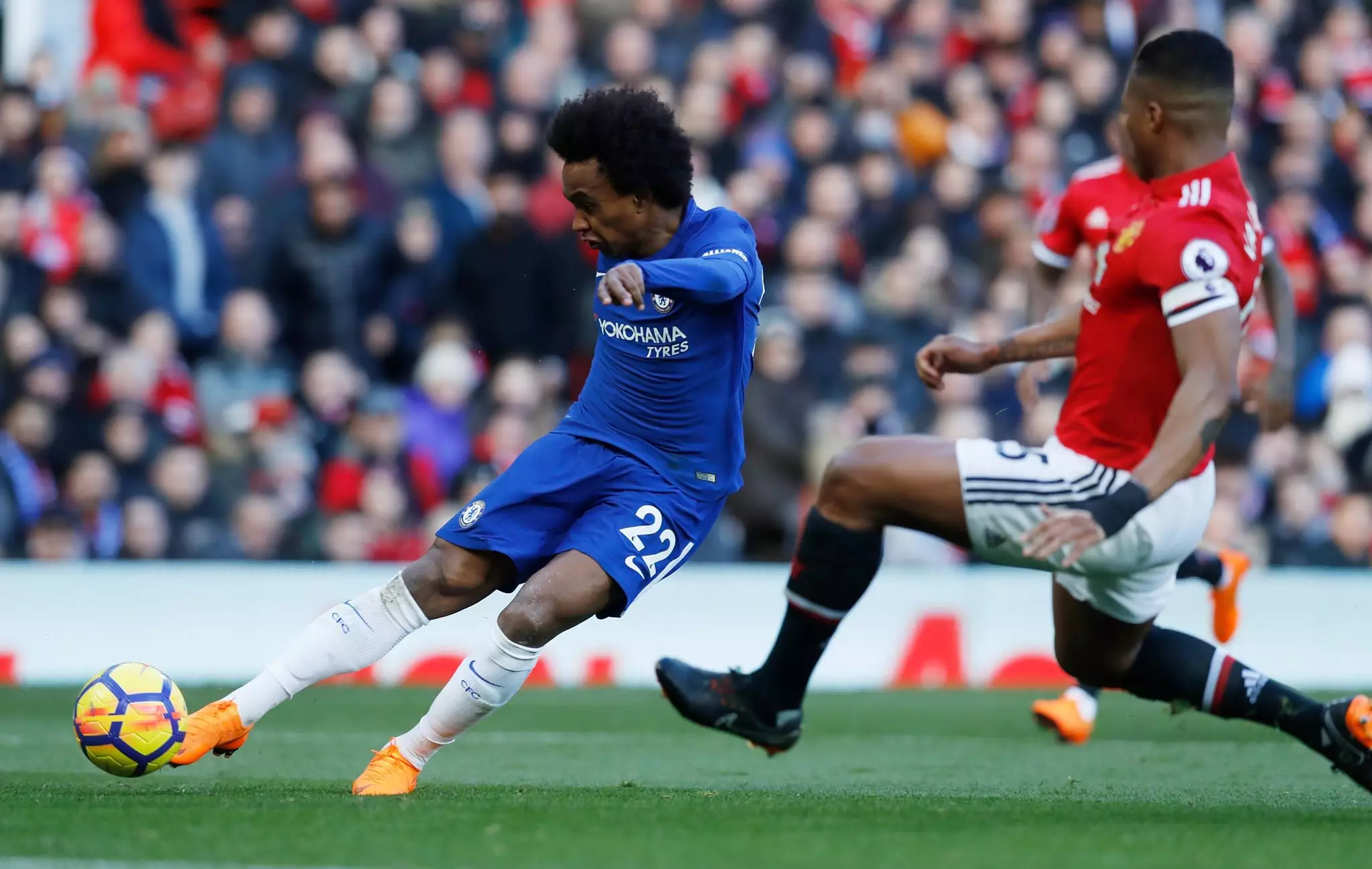 Willian scores a goal against United. Image: PA