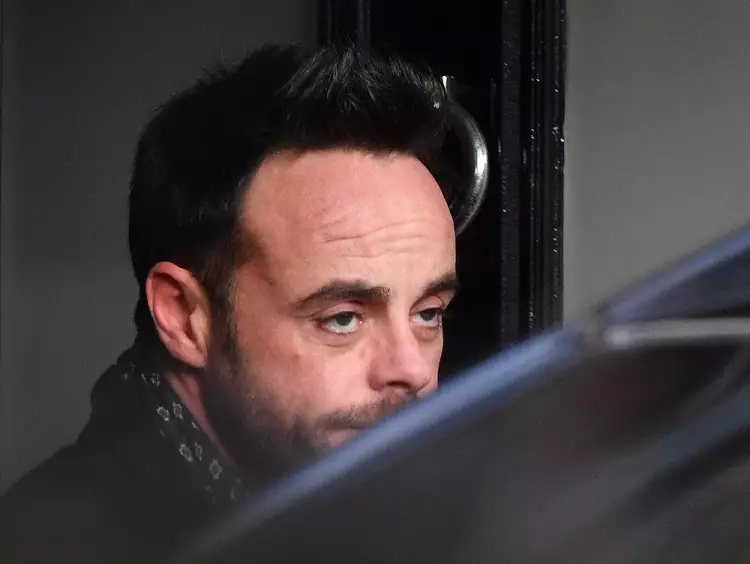 Ant McPartlin leaves a house in West London following his arrest.