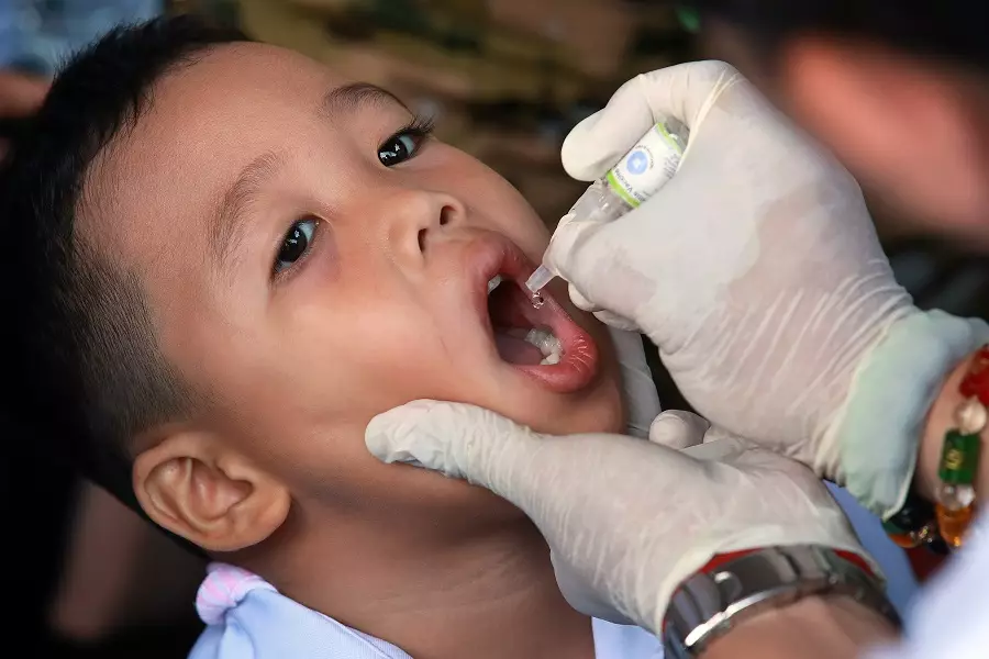 A boy receives an oral poliovirus vaccine during an anti-polio campaign.