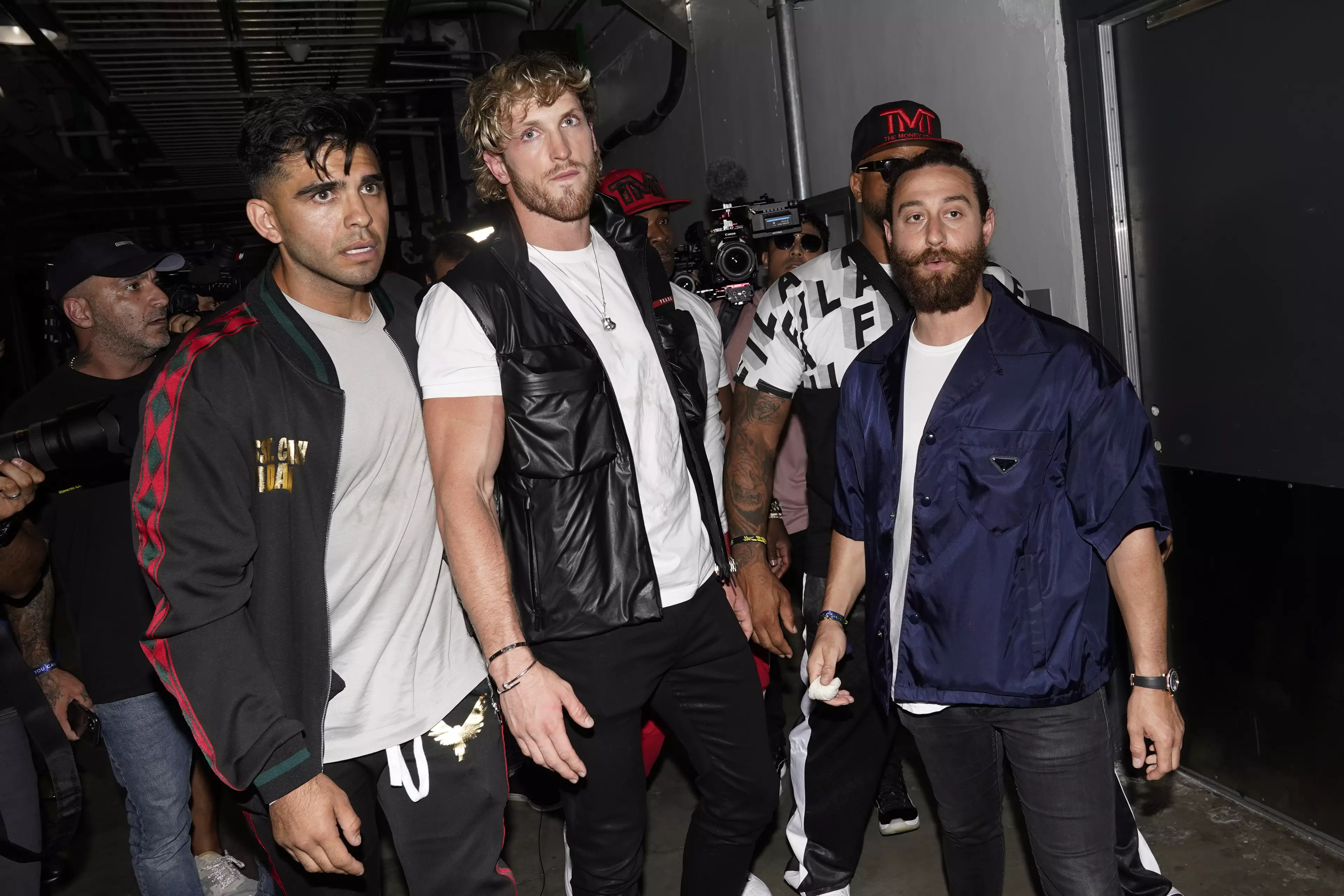 Logan Paul is held back by his team after Mayweather and Jake Paul's (not pictured) brawl. (Image