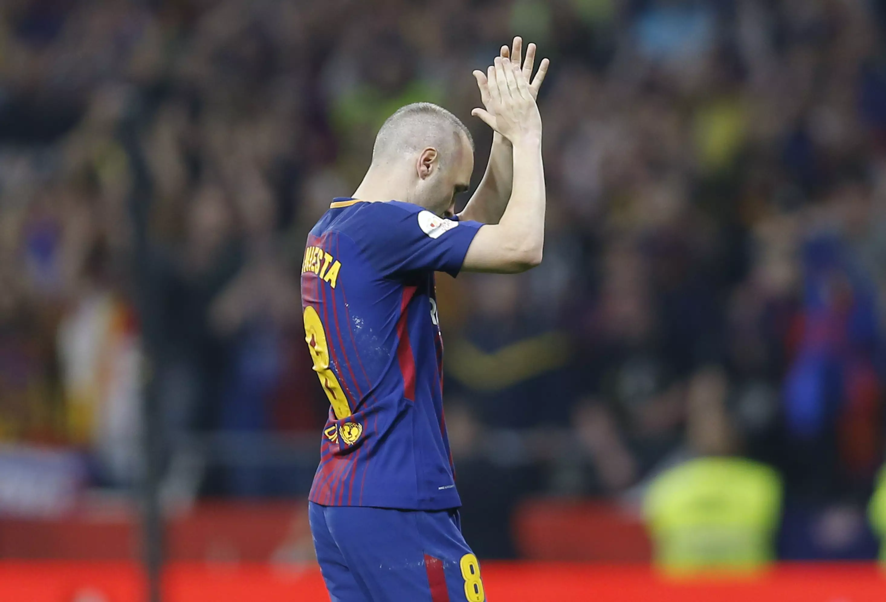 Iniesta leaves the pitch. Image: PA