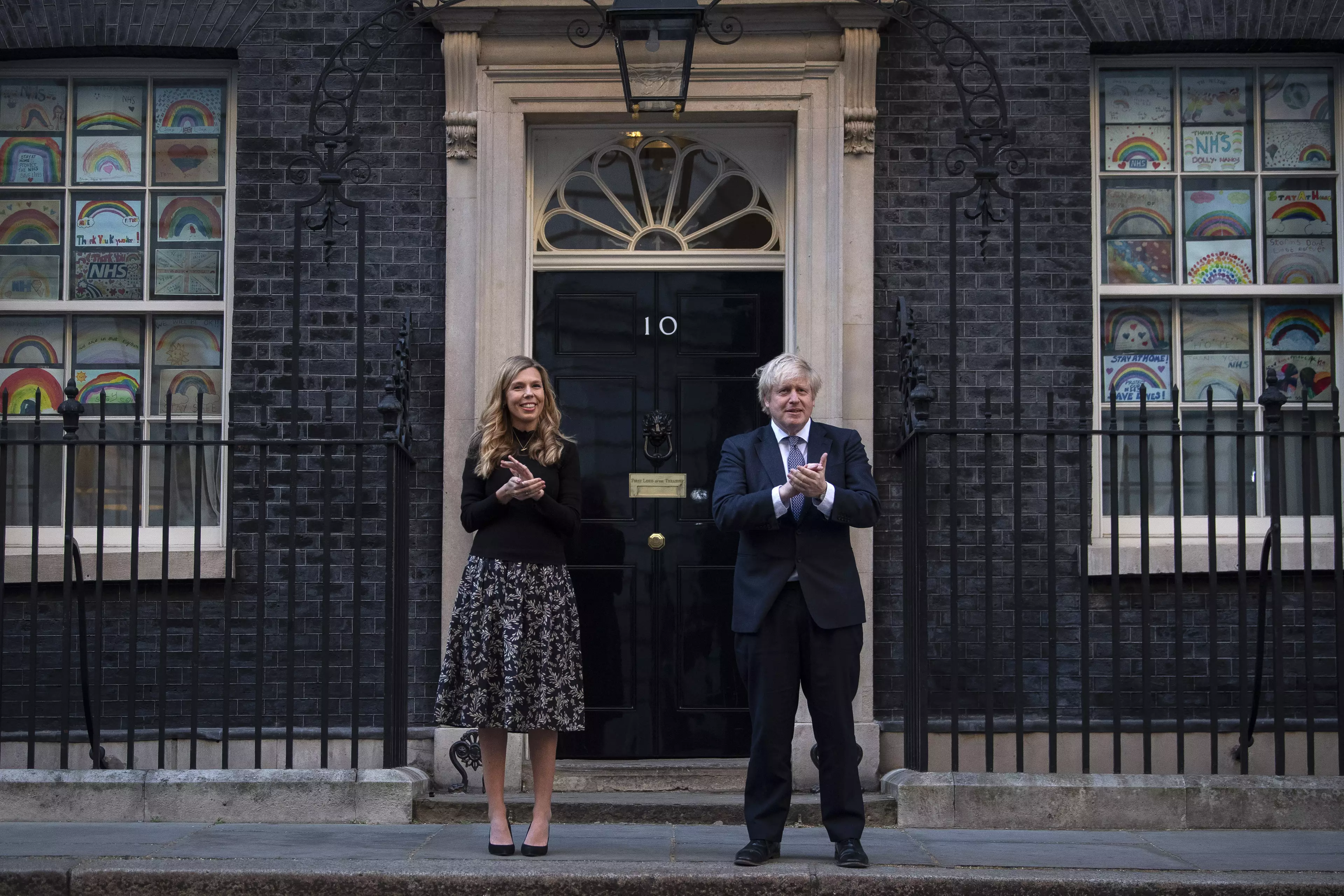 Boris Johnson and his partner Carrie Symonds outside 10 Downing Street in London, joined in the applause to salute local heroes during the nationwide Clap for Carers (