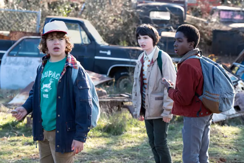 Finn (middle) with co-stars on the set of Stranger Things.