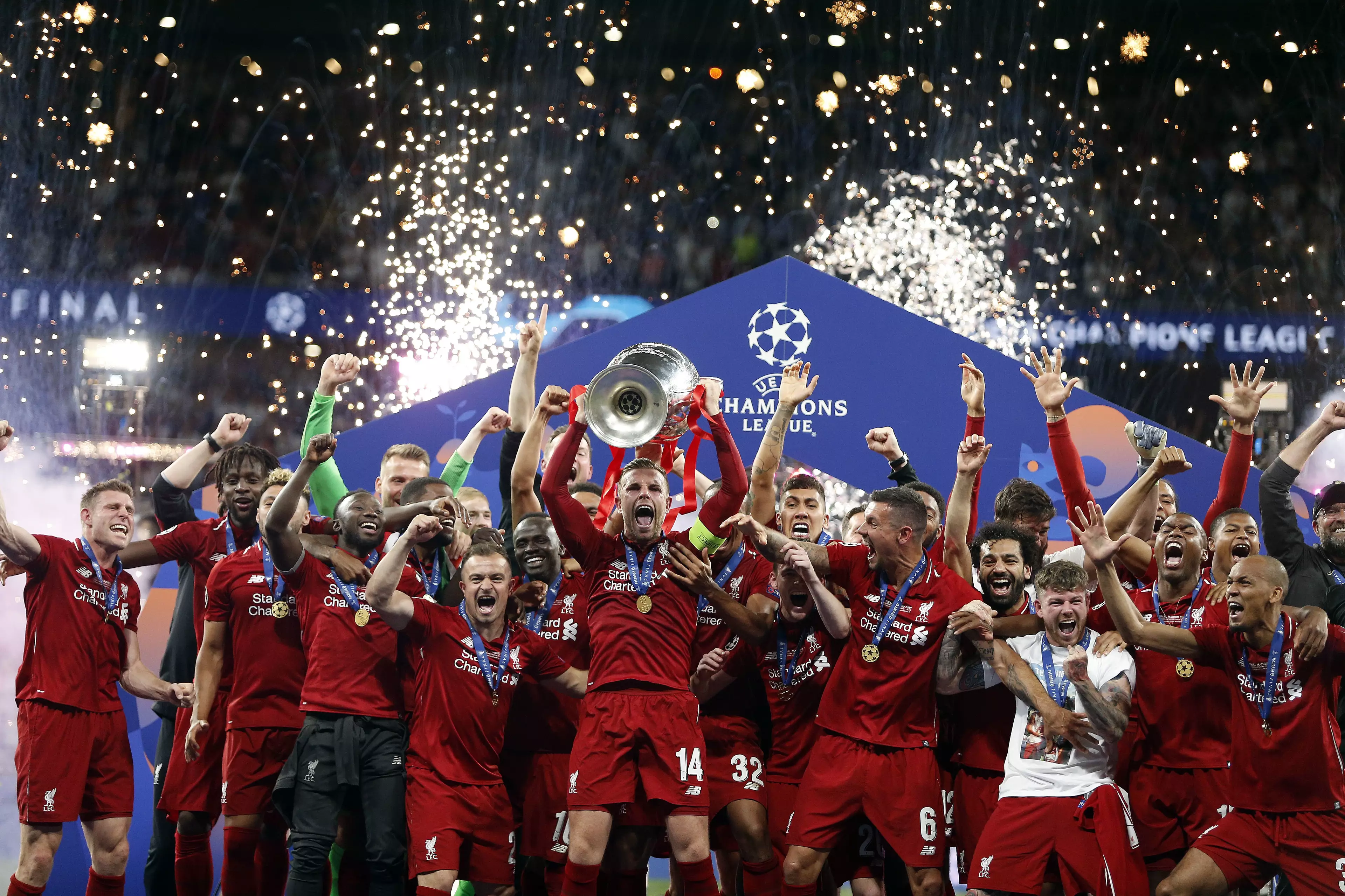 Liverpool players celebrate with their trophy. Image: PA Images