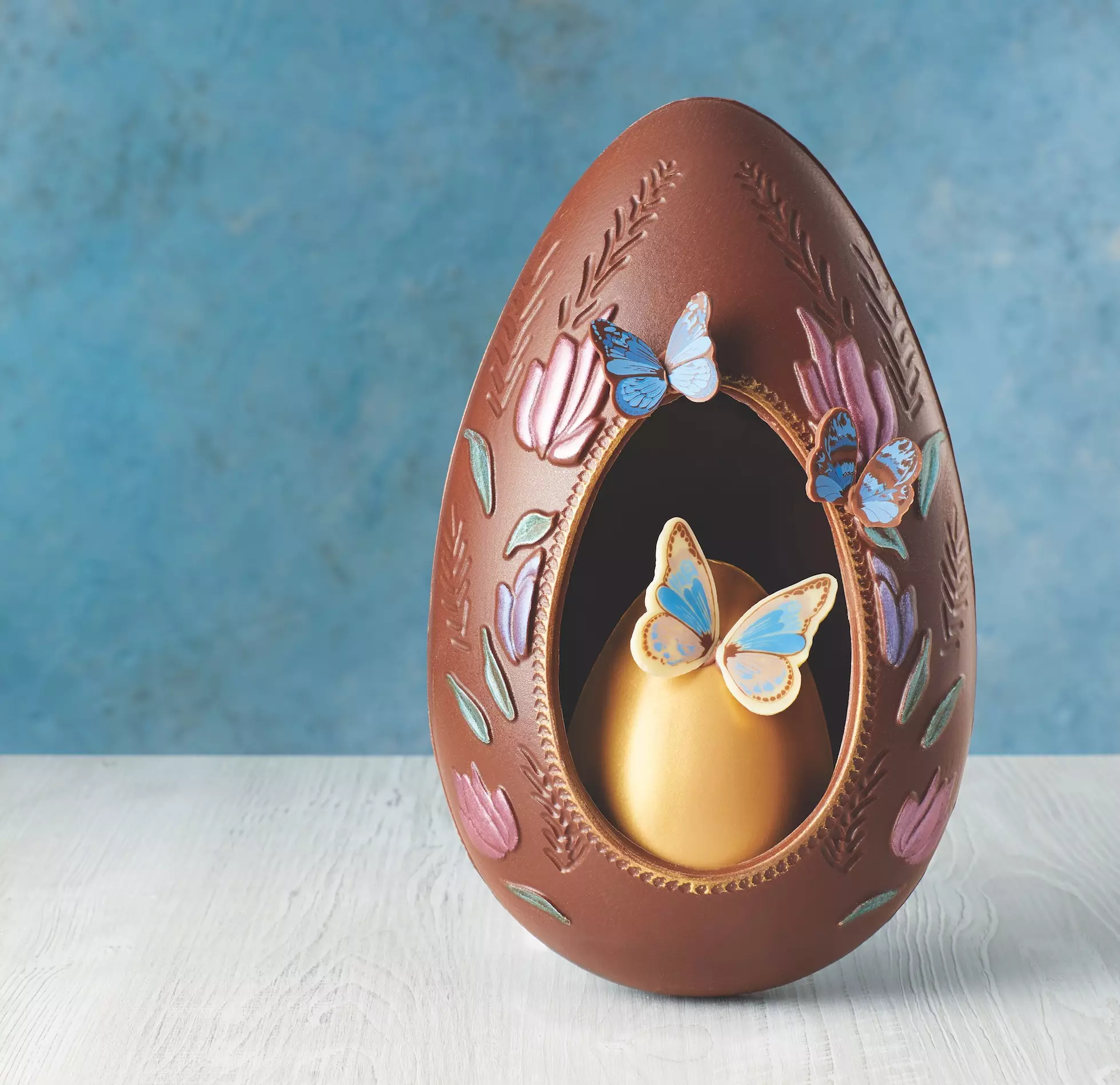 This egg is beautifully hand decorated with butterflies and has a second egg inside (