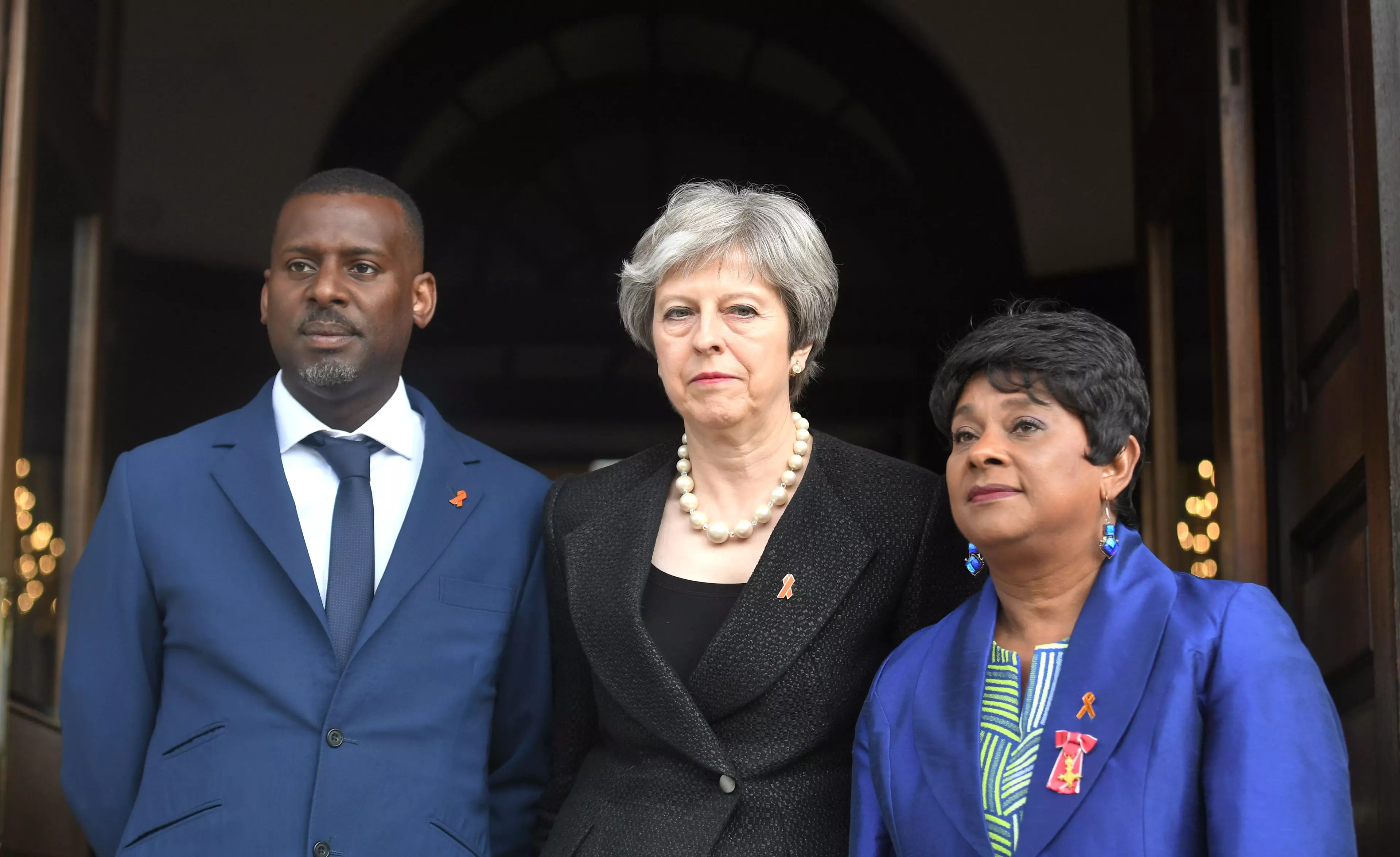 Theresa May with both of Stephen Lawrence's parents in 2018 (