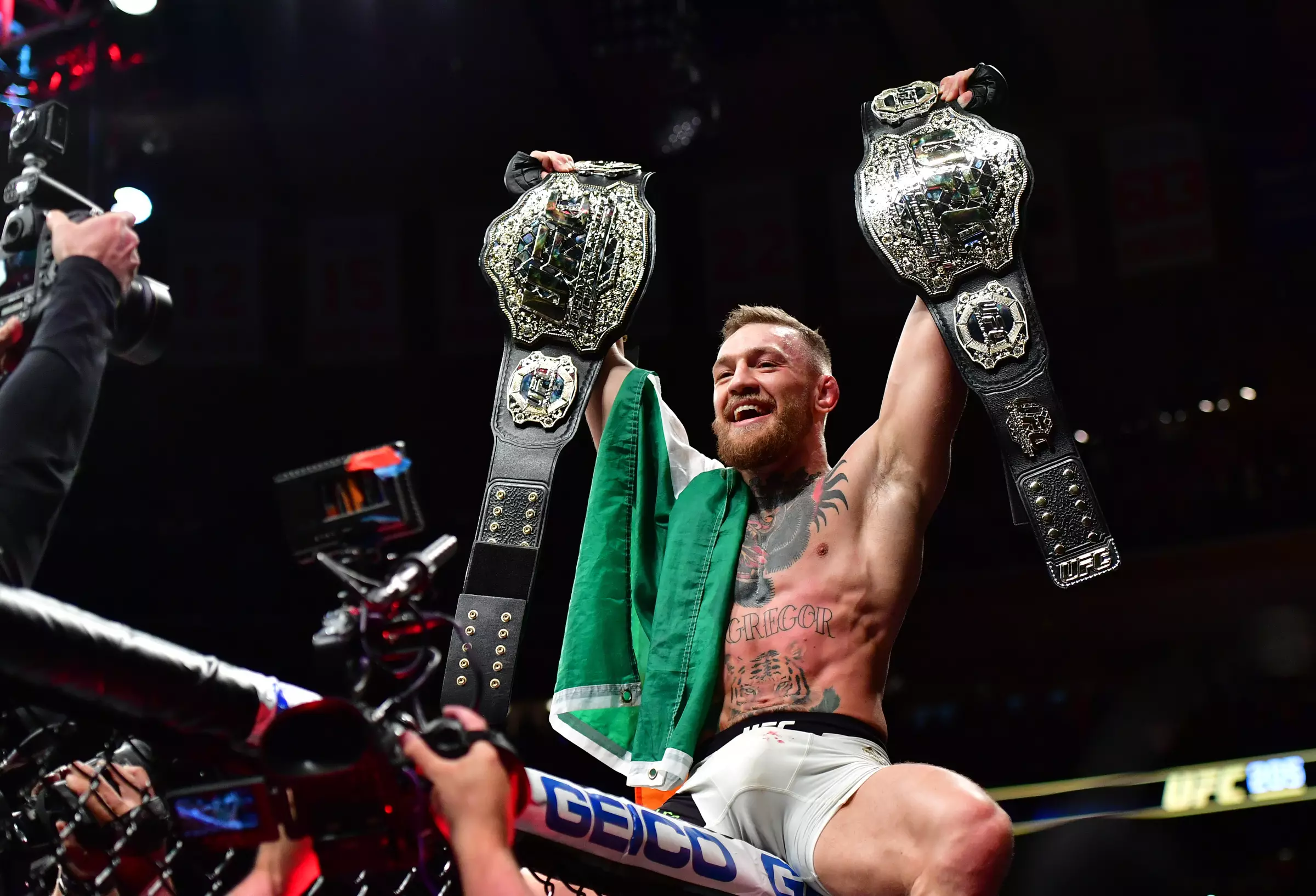 McGregor holds up his two UFC titles following victory at UFC 205. Image: PA