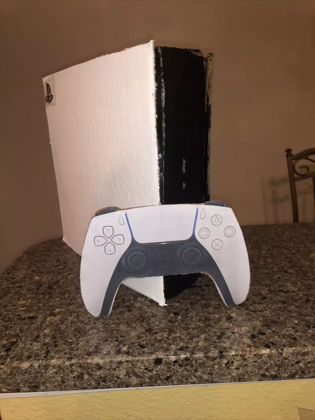 The cardboard PS5 with its cardboard controller /