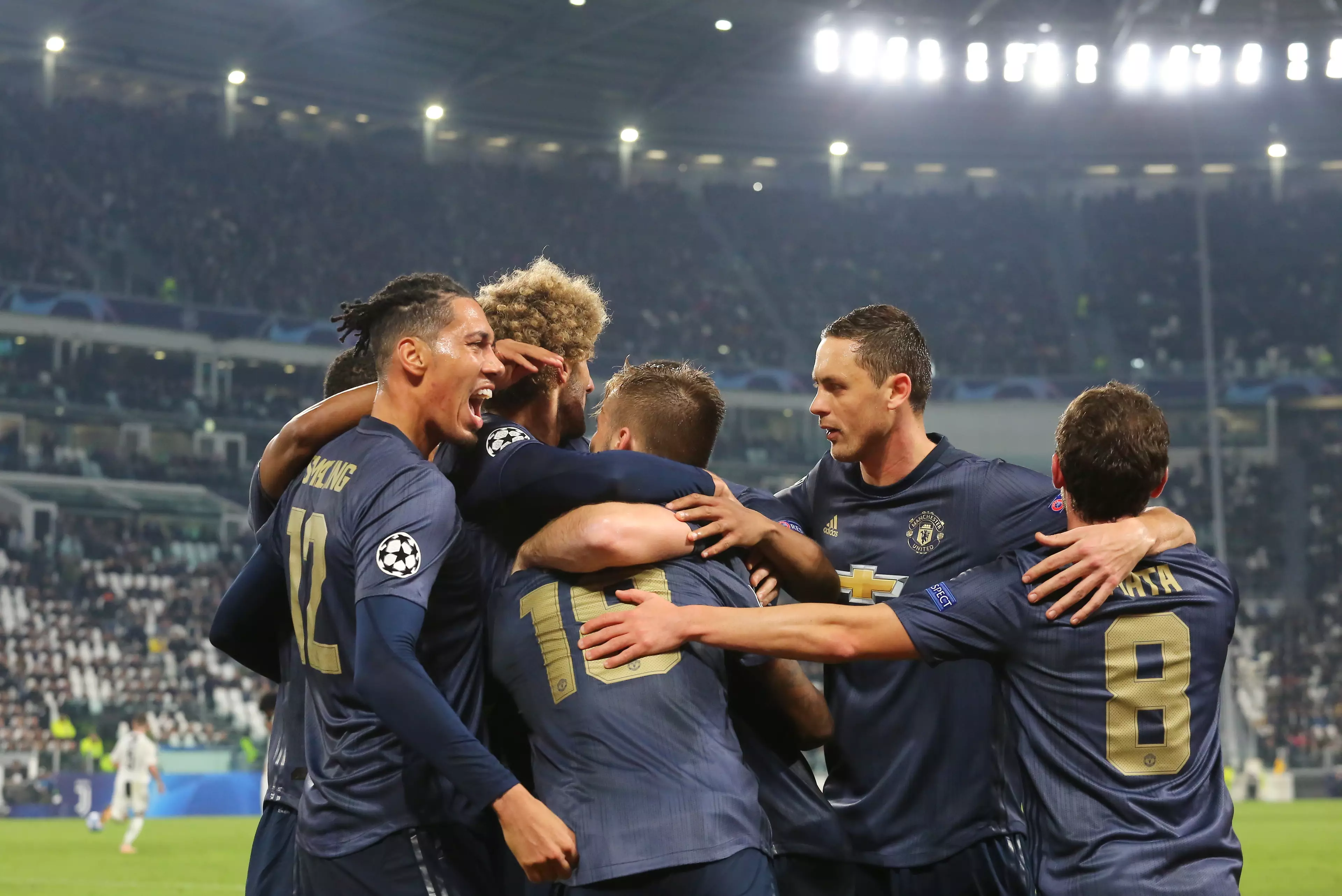 Manchester United players celebrate after their winner vs Juventus (