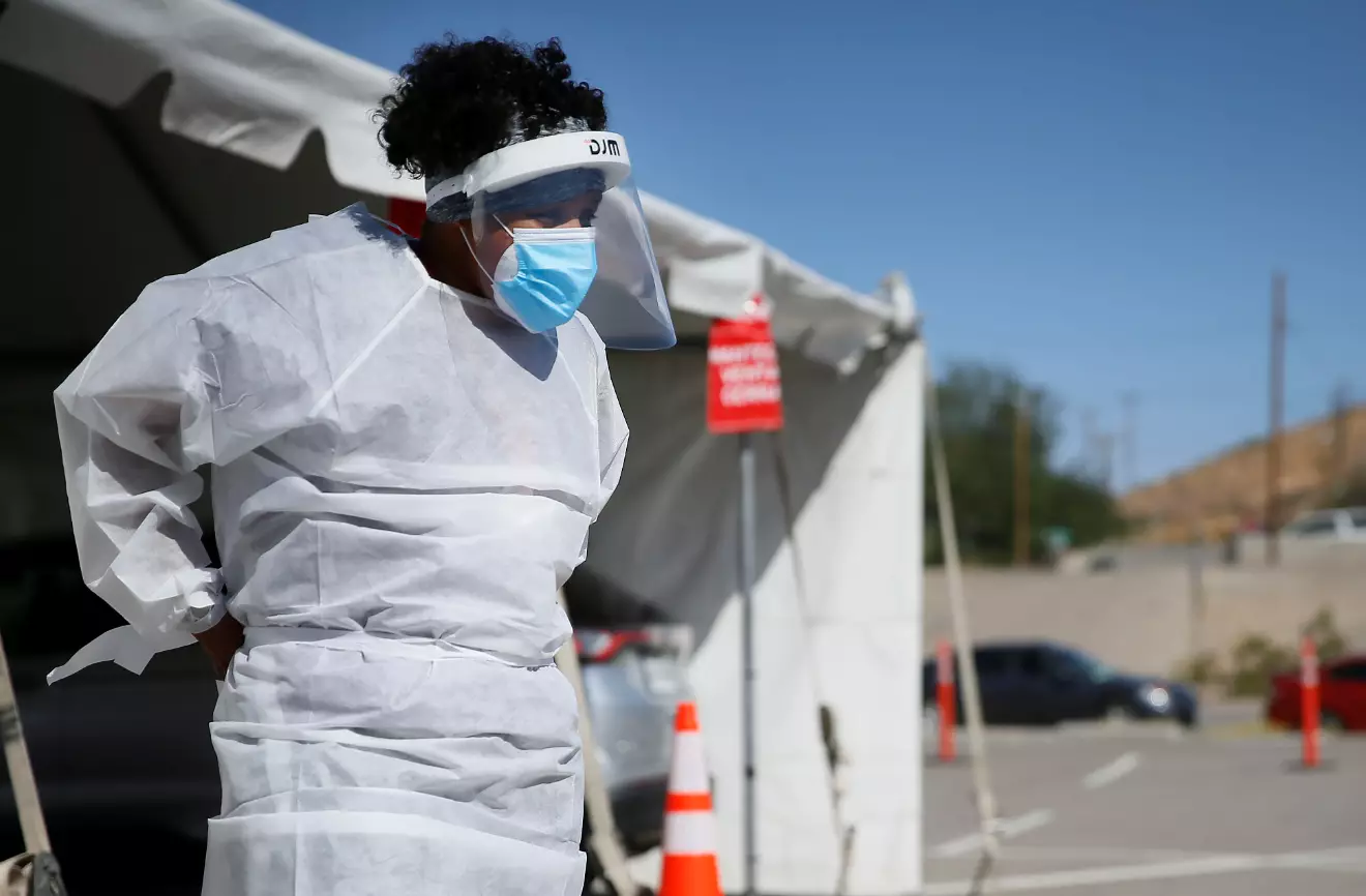 A medical worker stands at a Covid-19 state drive-thru testing site at UTEP, in El Paso, Texas.