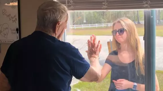 Woman Shows Grandfather Engagement Ring Through Window Due To Coronavirus Restrictions