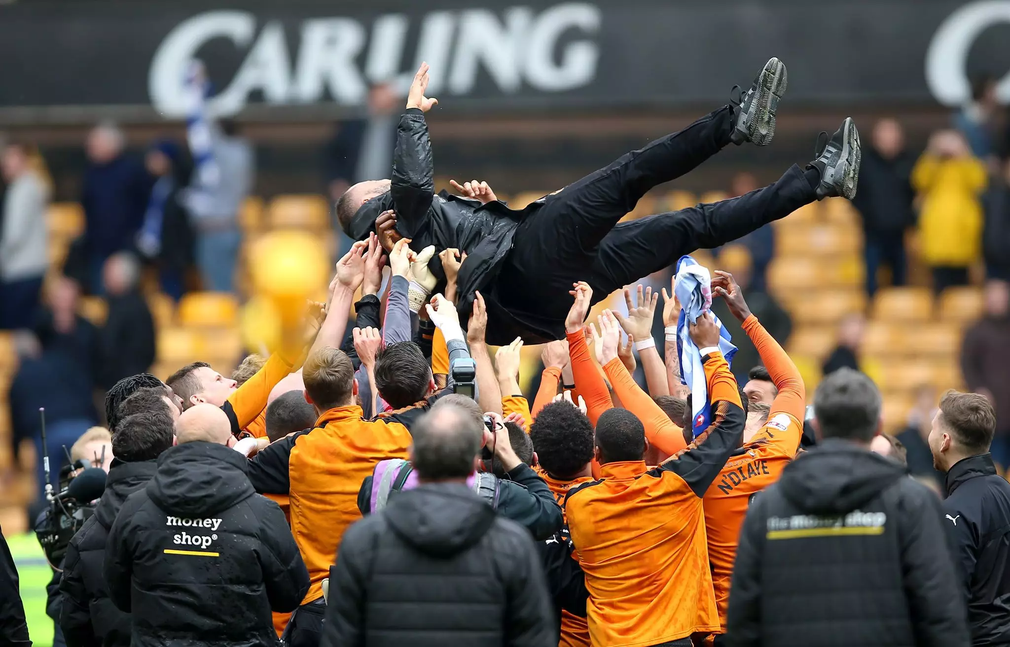 Wolves players hurl Nuno up in the air. Image: PA