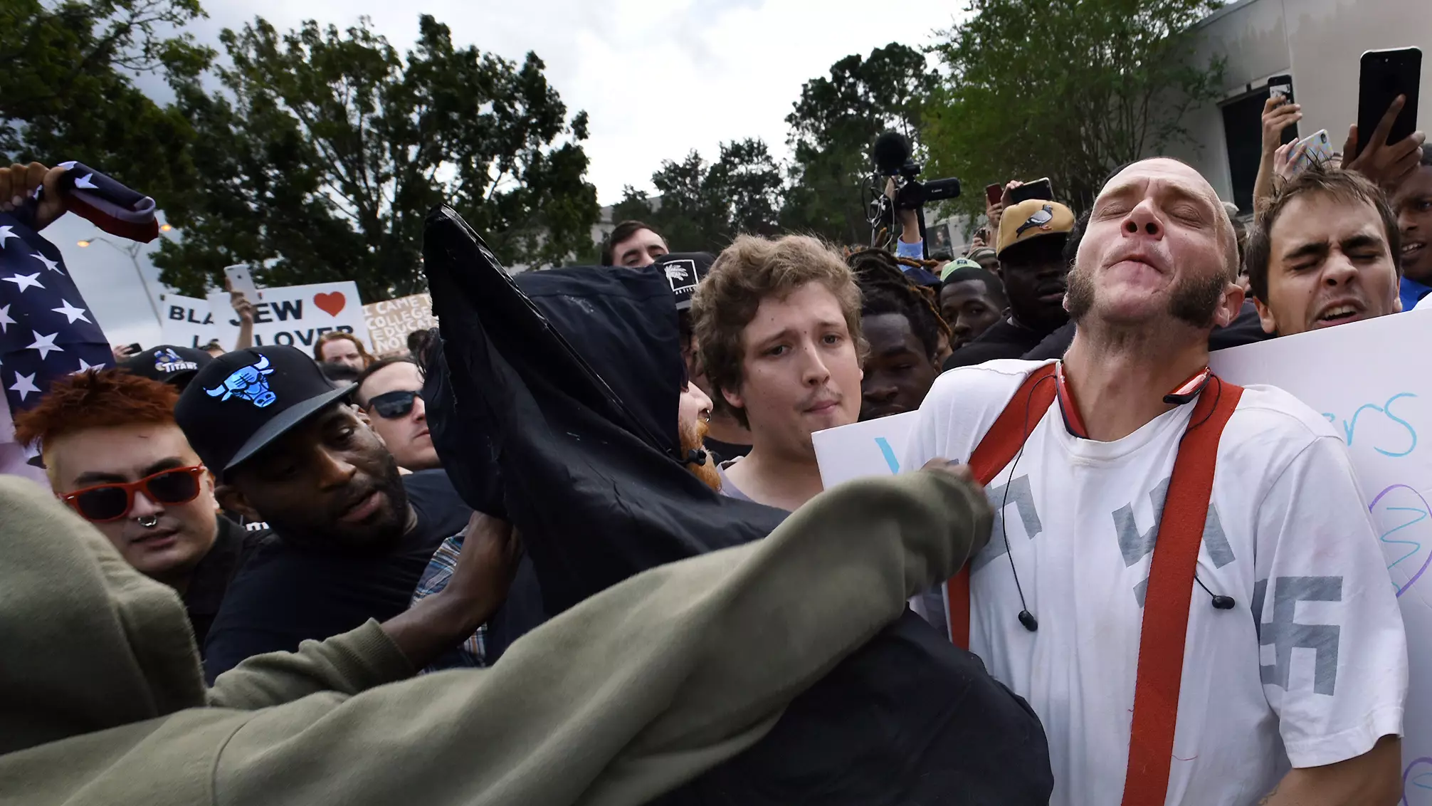 Black Protester Gives Neo-Nazi A Hug And Stops His From Being Attacked