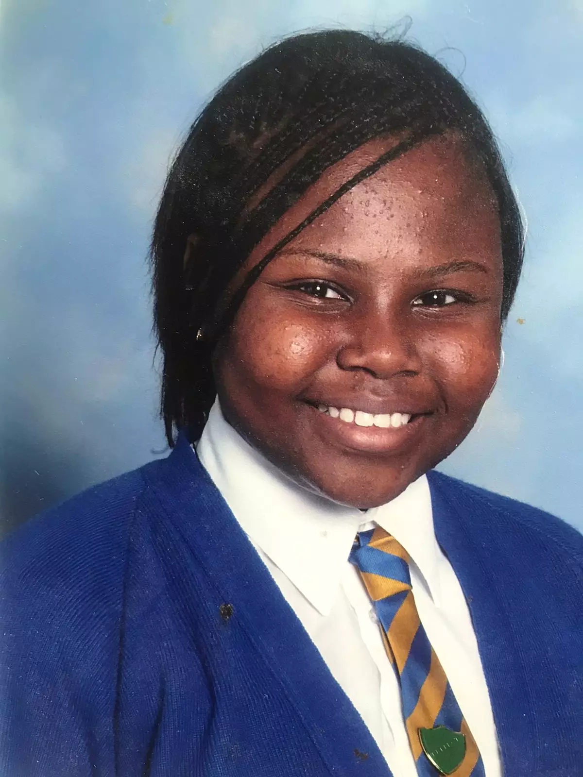 Nikki in Year 6 wearing her natural hair in braids. Growing up she was desperate for her curls to be 'straight and slick' (
