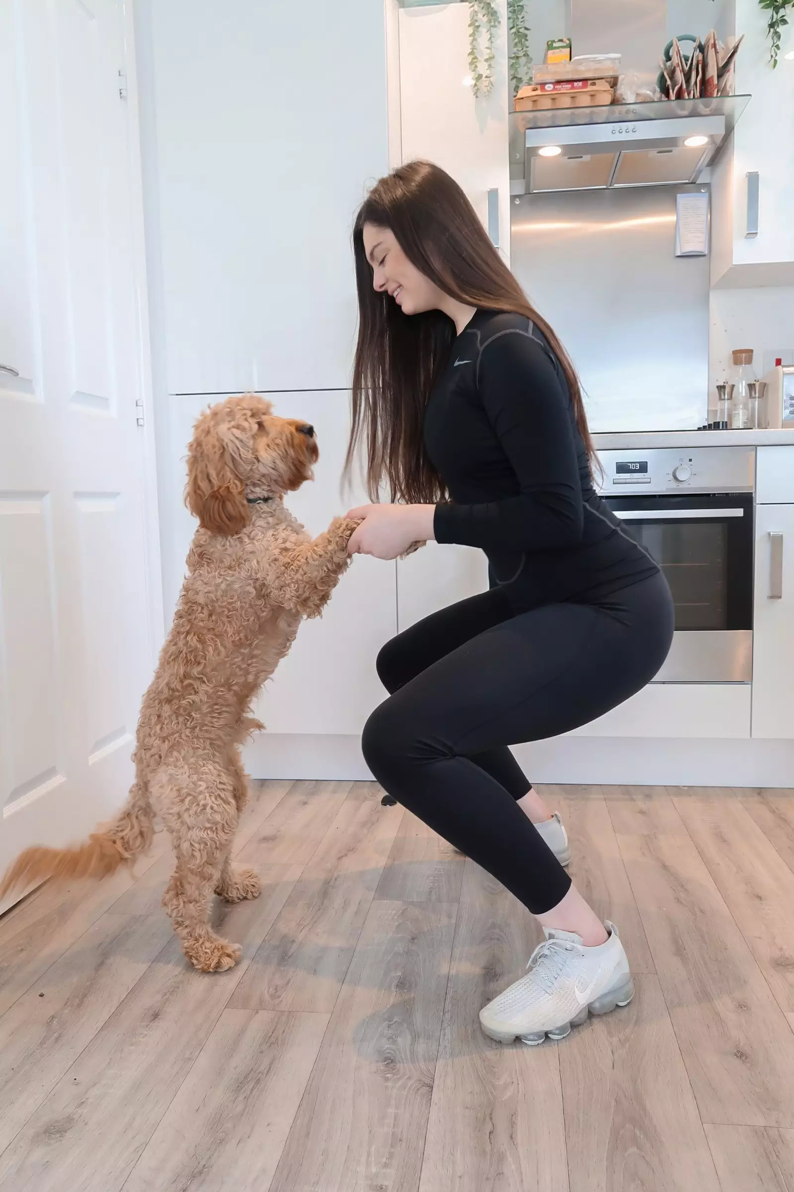 Squat whilst holding both your dog's paws so they are on their hind legs for added resistance, says Amy (