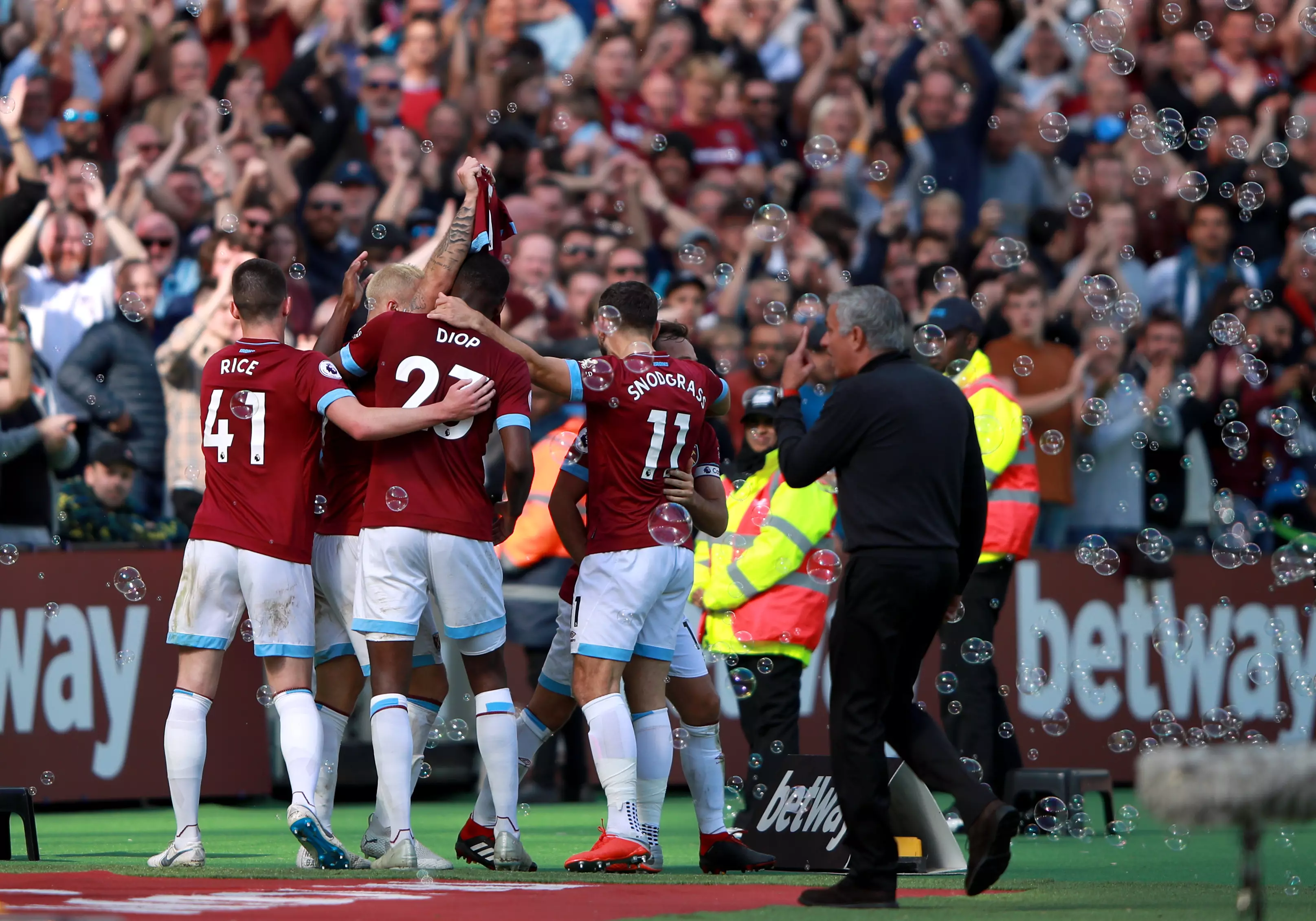 As West Ham players celebrate their third goal Mourinho looks pretty annoyed. Image: PA Images
