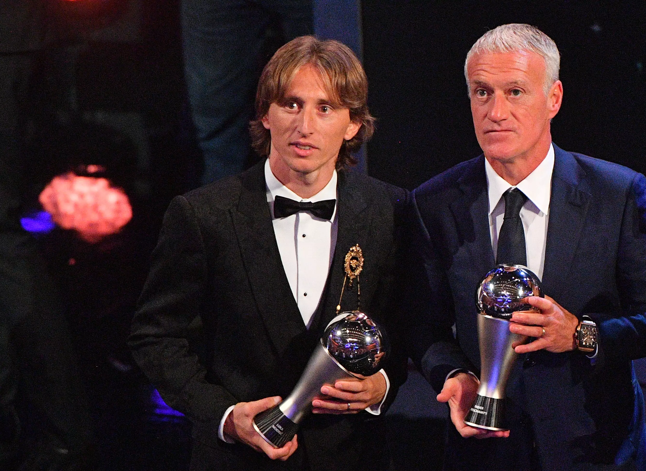 Modric, alongside FIFA's best manager Didier Deschamps, with his award. Image: PA Images