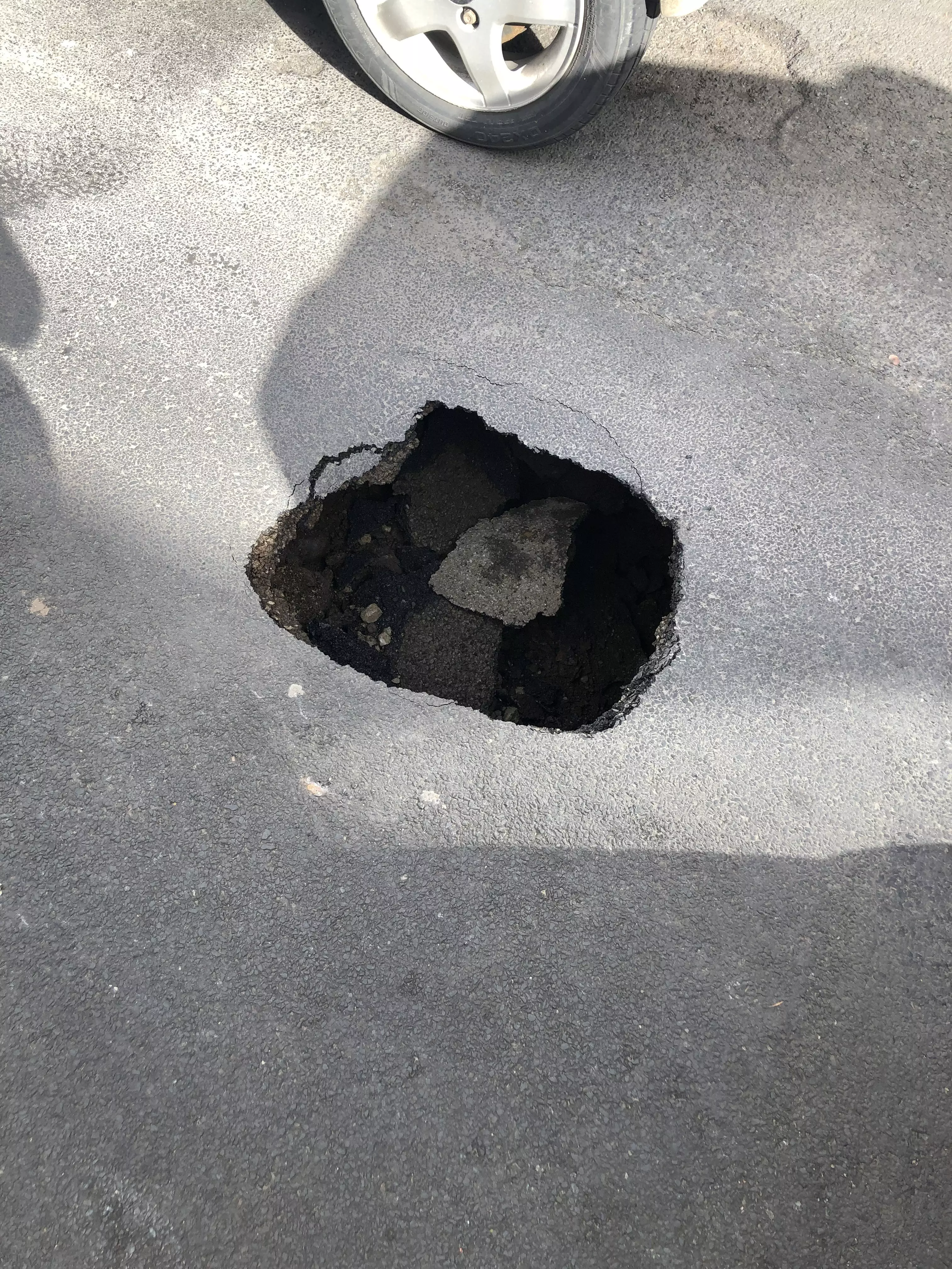 The huge hole opened up following recent work on the road.