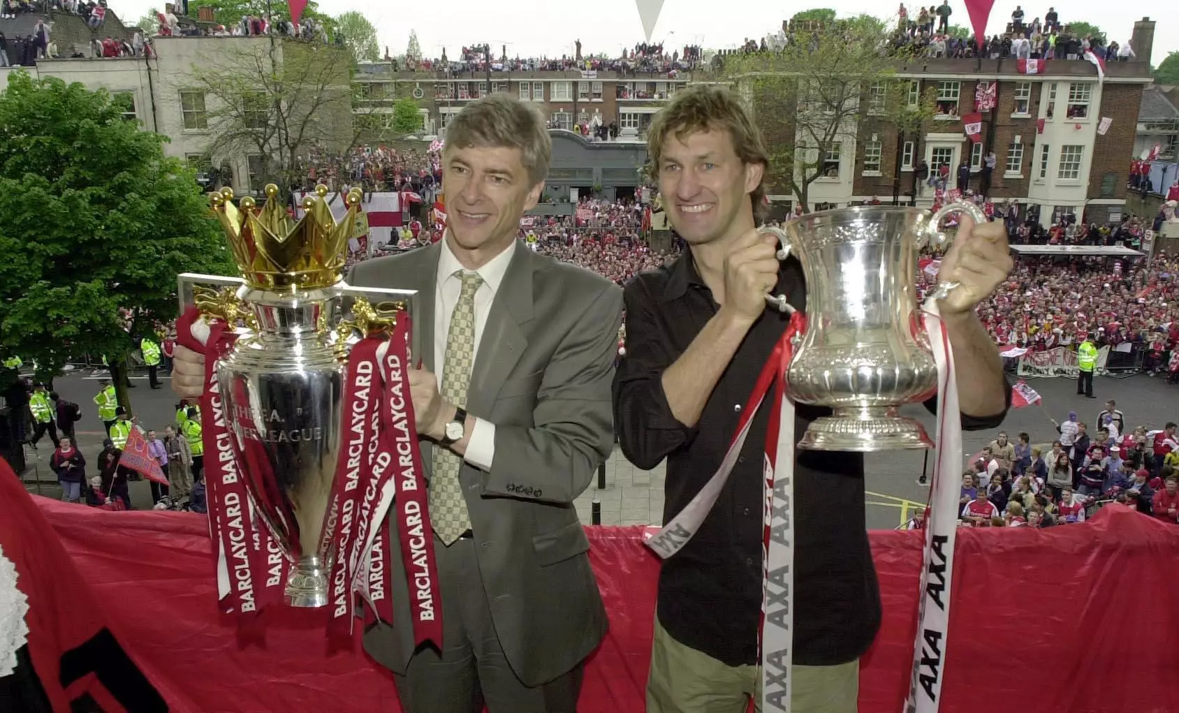 Wenger (L) and former Arsenal captain Tony Adams (R) holding the Premier League and FA Cup trophy. (Image