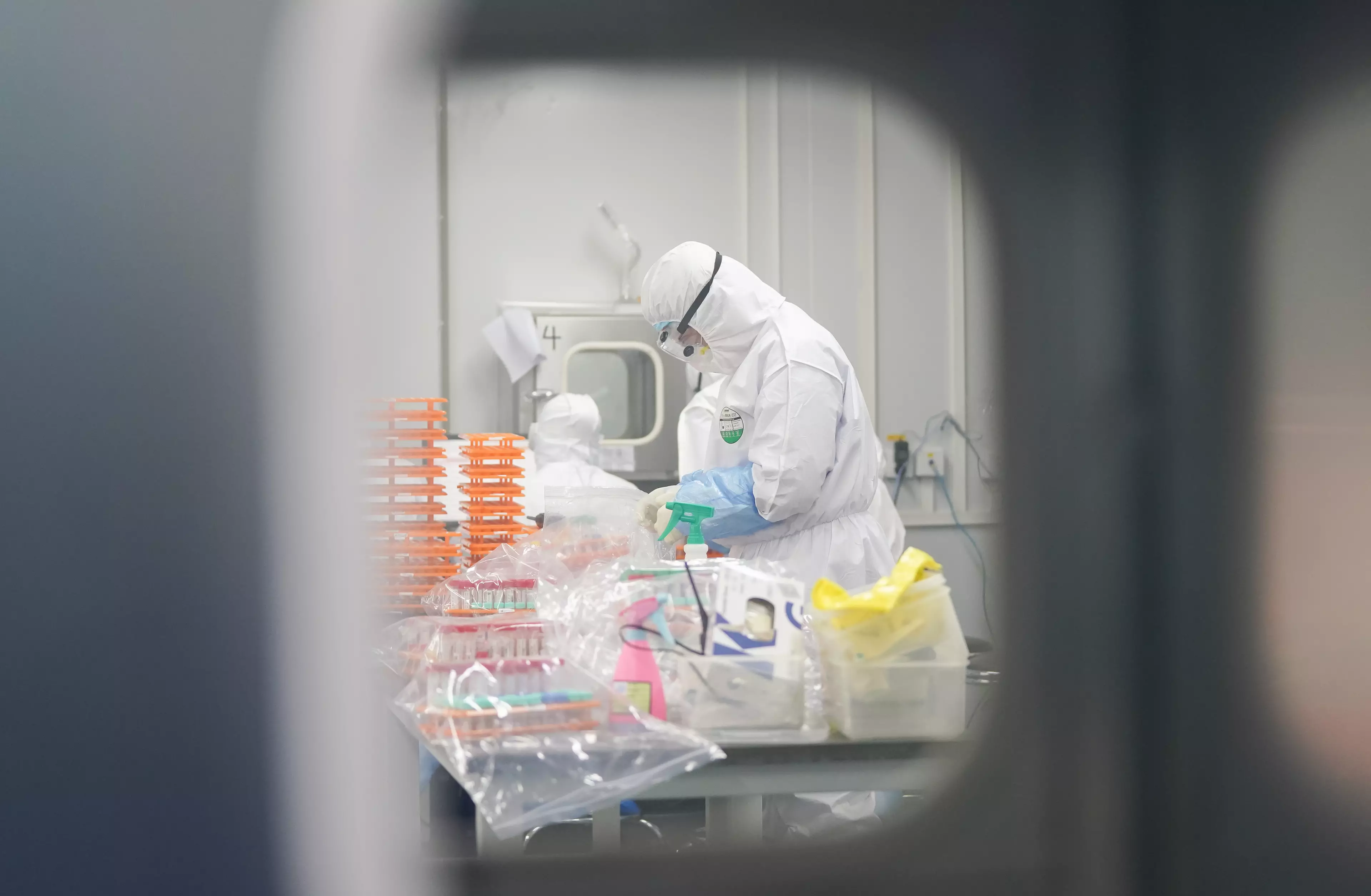 A staff member handles nucleic acid testing samples at a novel coronavirus detection lab in Wuhan, central China's Hubei Province.