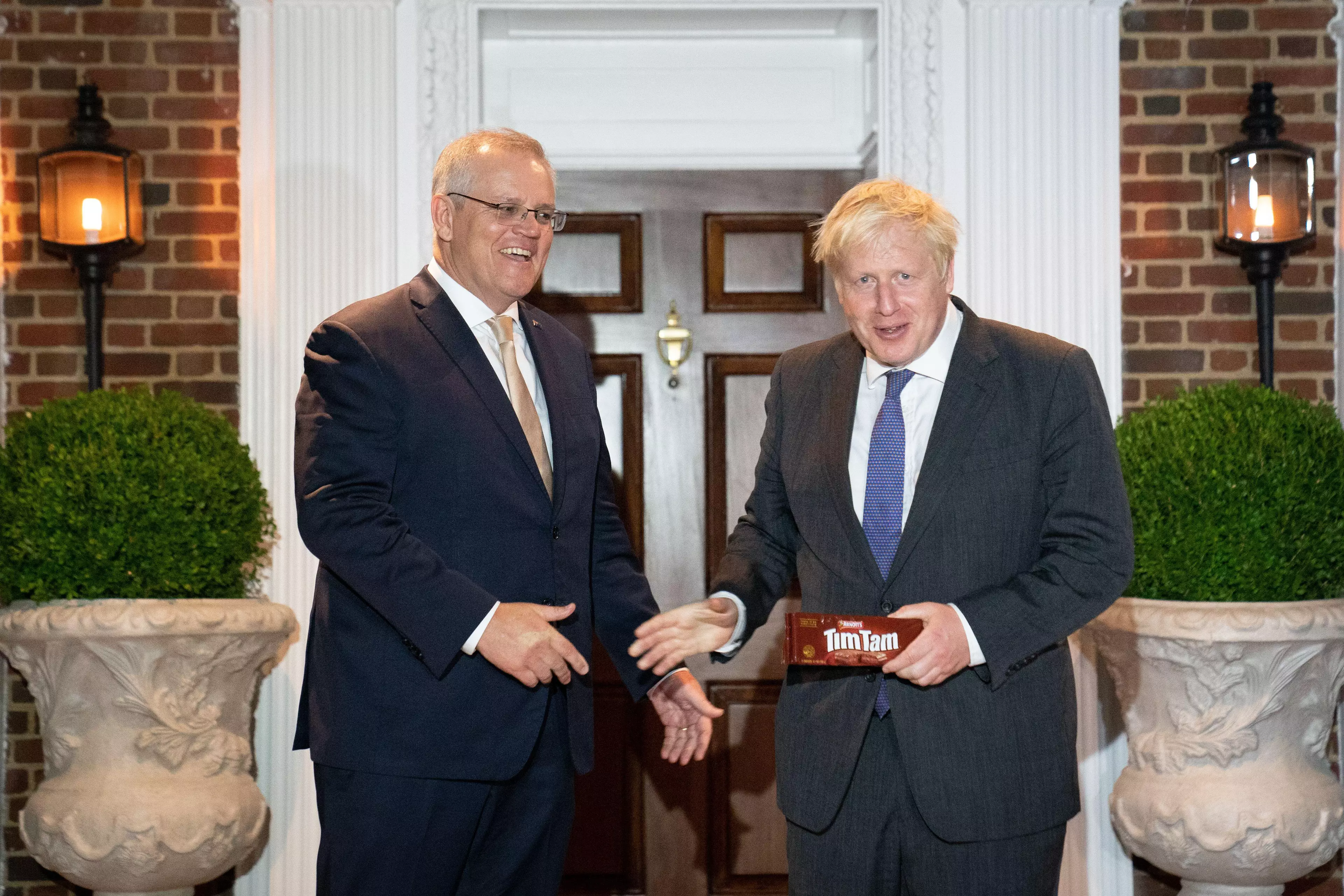 Scott Morrison gifts Tim Tams to Boris Johnson.