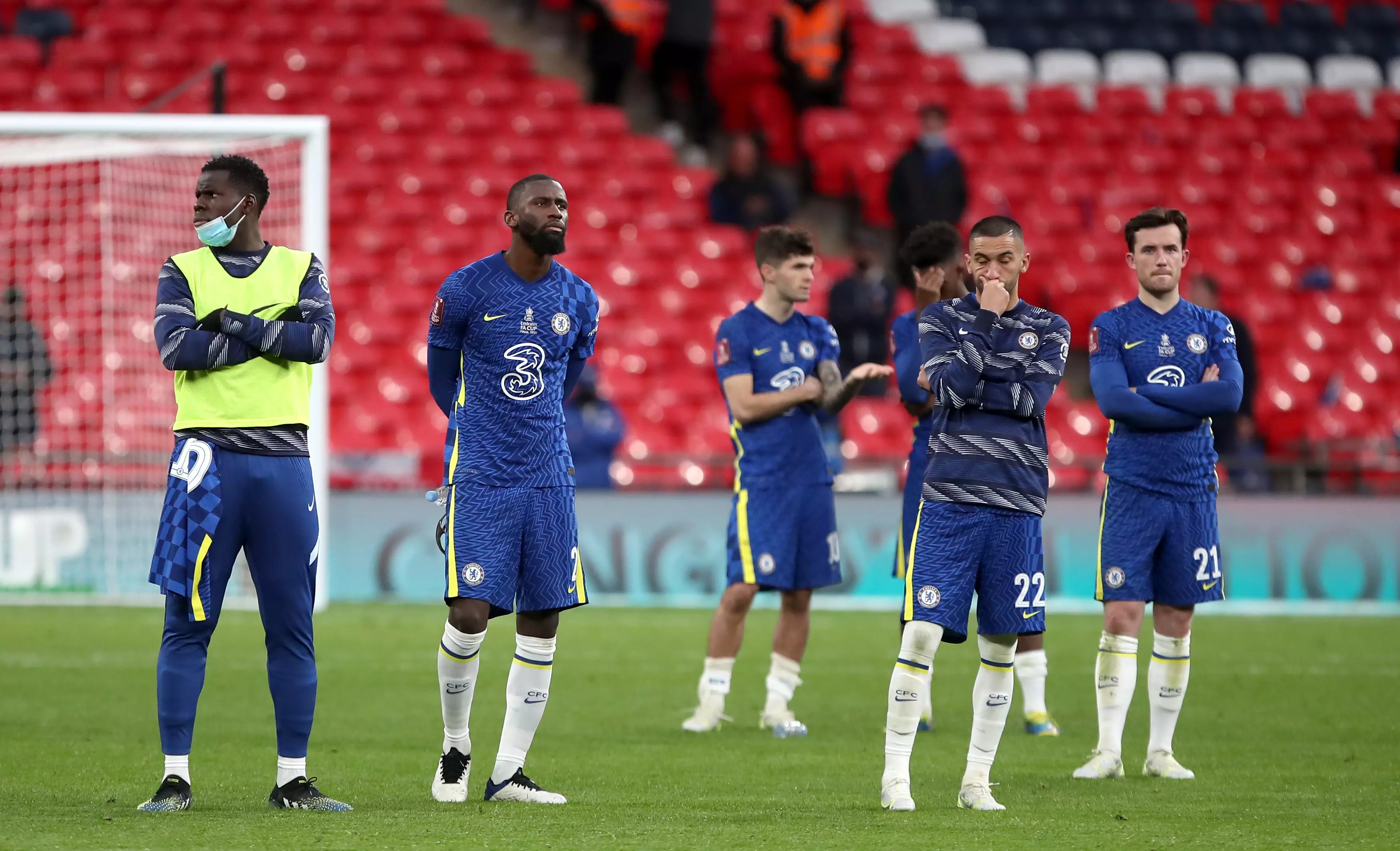 Chelsea players look on as Leicester celebrate their win. Image: PA Images