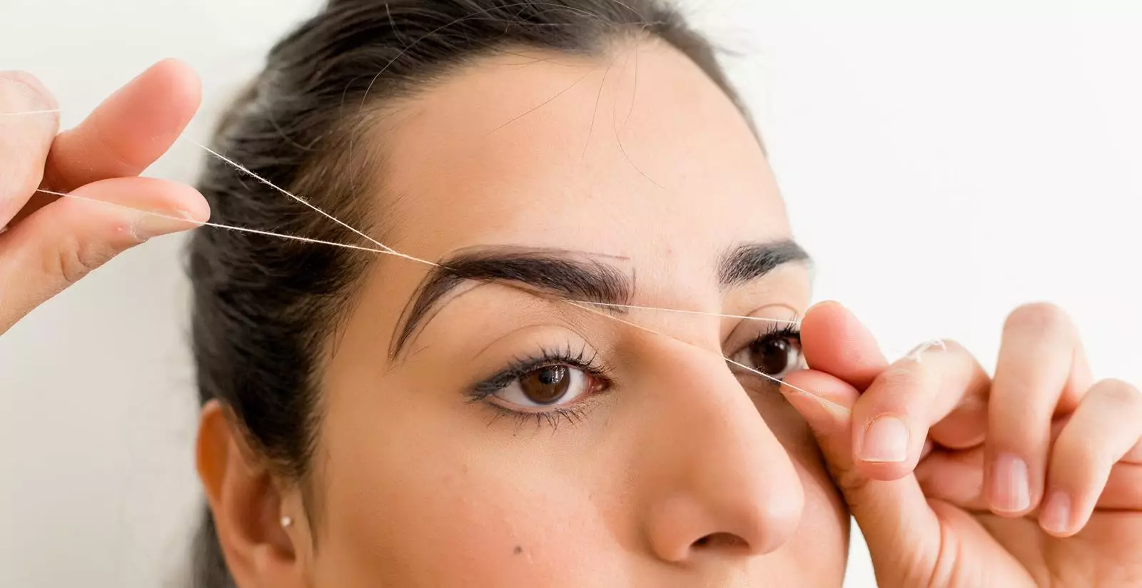 Do subtle, minimal tidying under the brows, above the eyelids and your brow tails. Don't overdo it! (