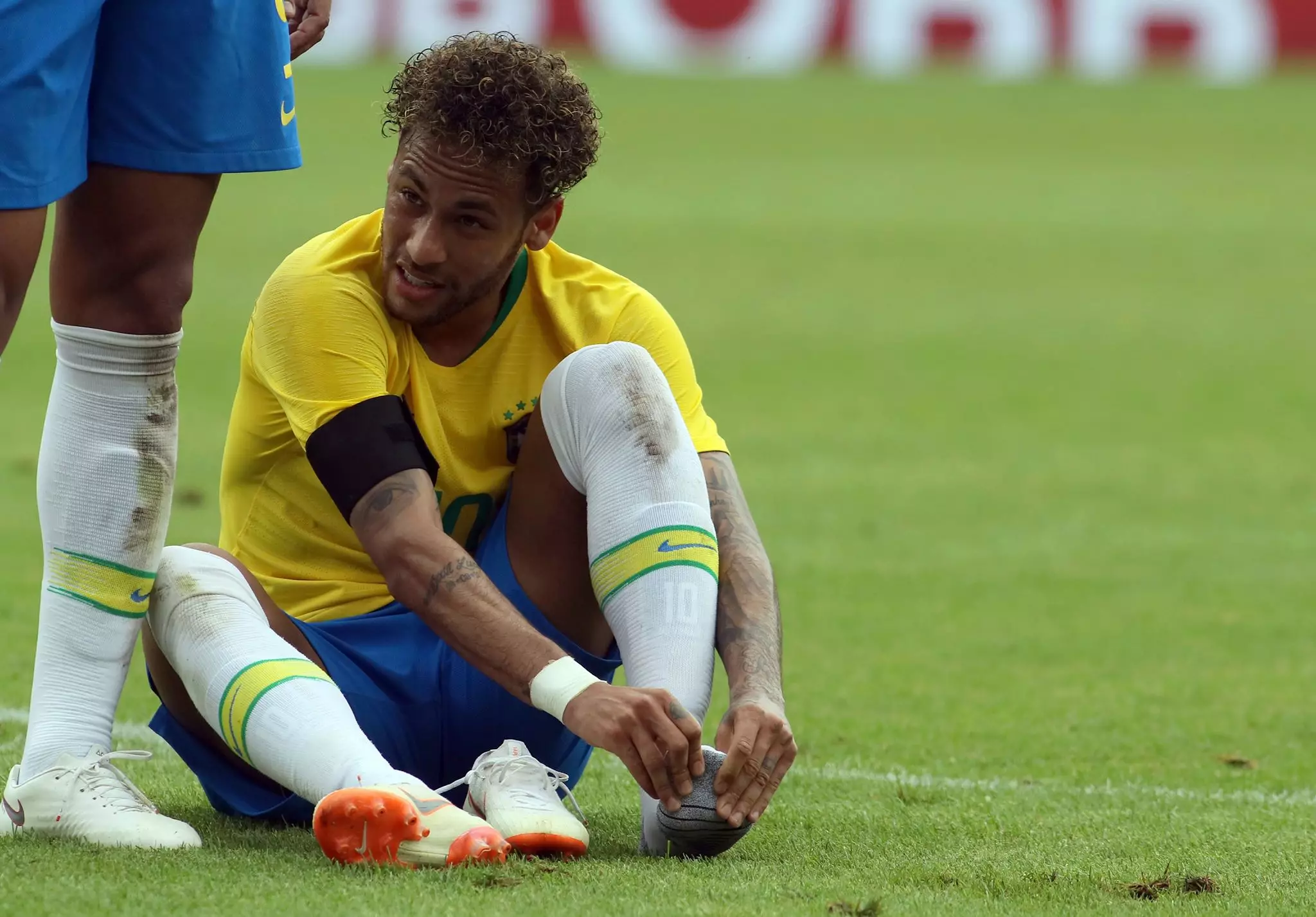 Neymar holds his foot. Image: PA