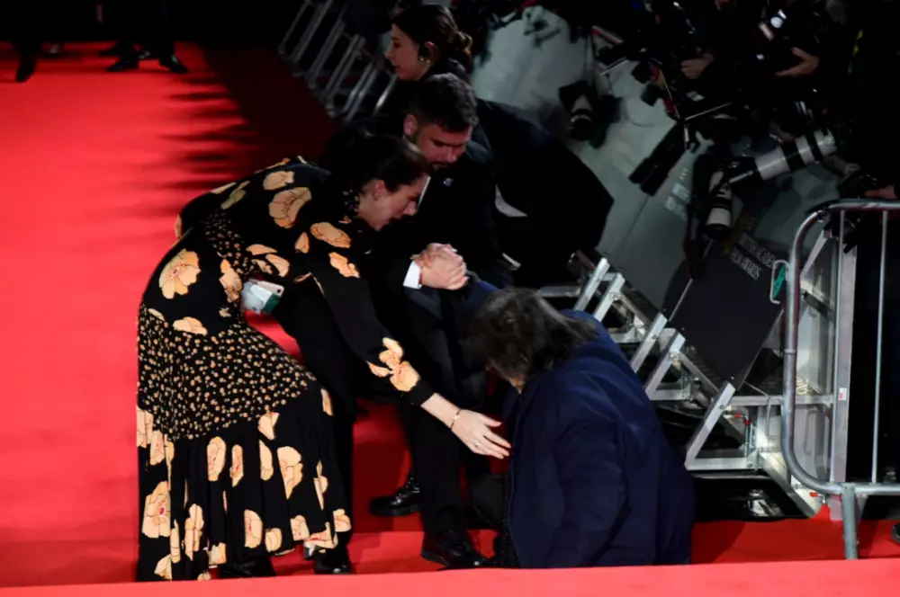 Al Pacino trips over on the red carpet for the BAFTAs.