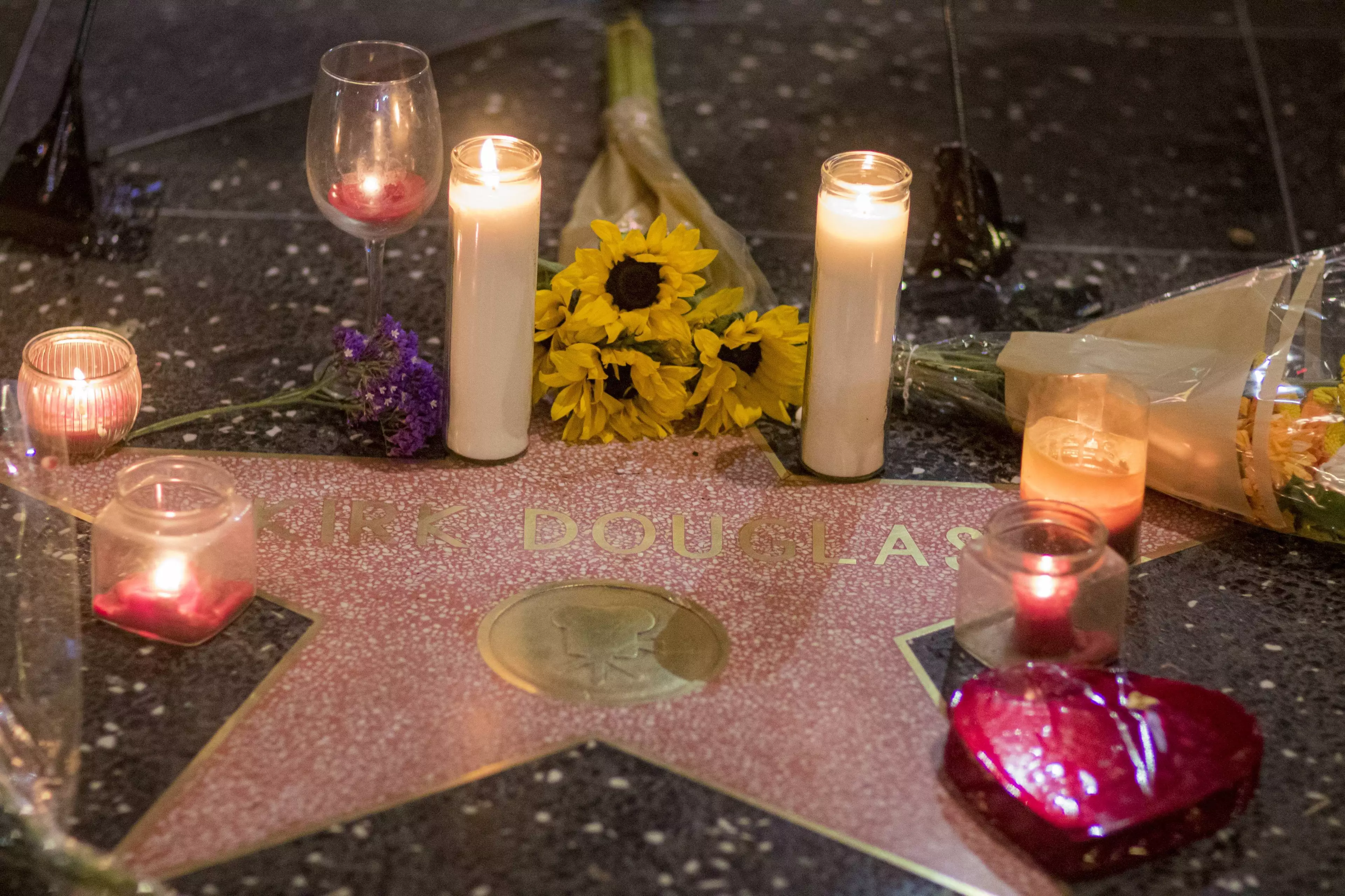 Expressions of mourning on Kirk Douglas' star on the Hollywood Walk of Fame.