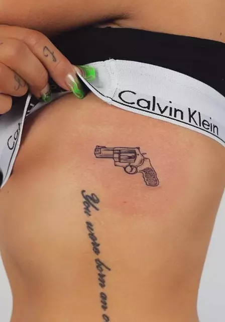 The small ink of a gun is on Jesy's torso. (