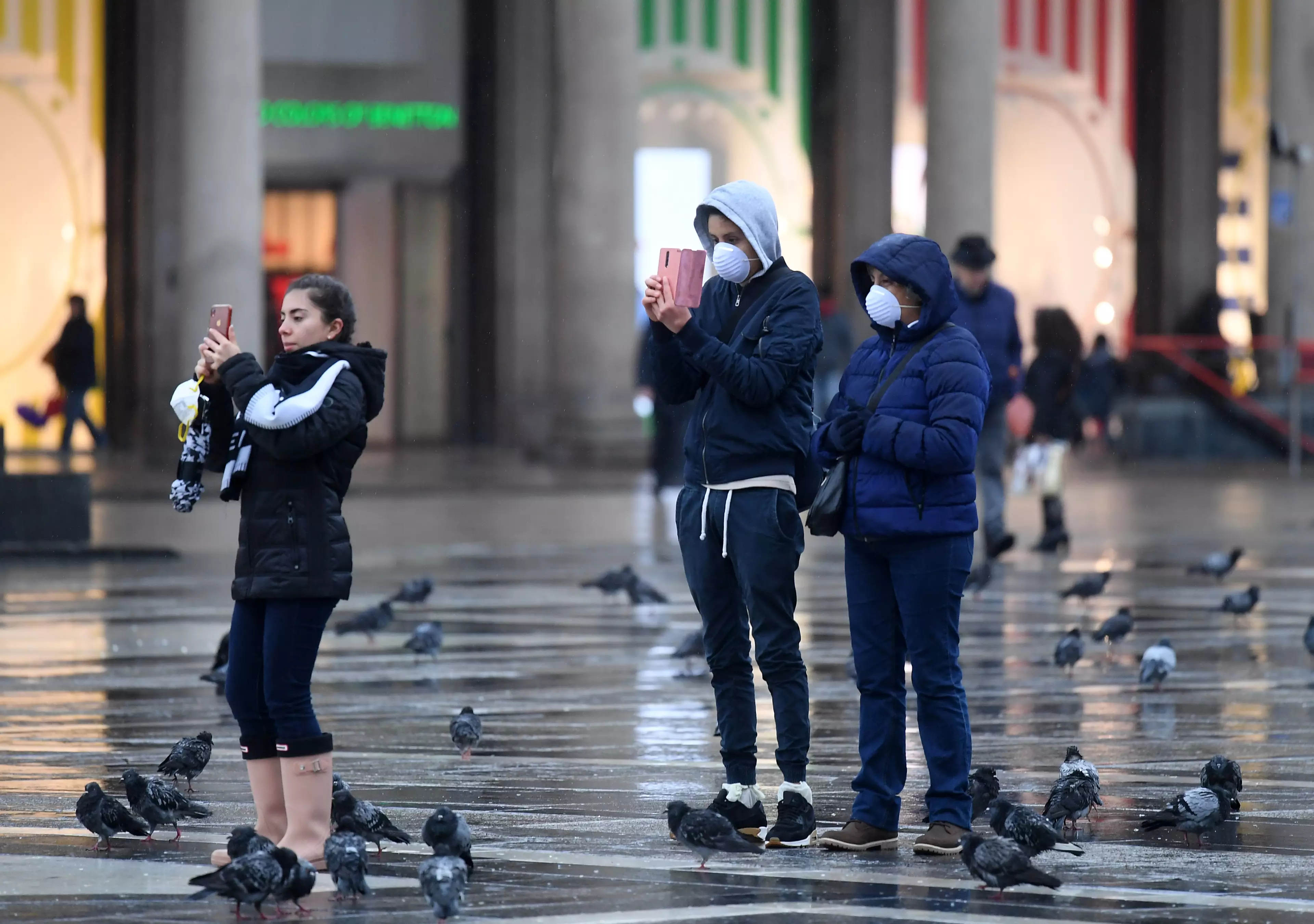 Pedestrians wearing face masks on the streets of Italy.