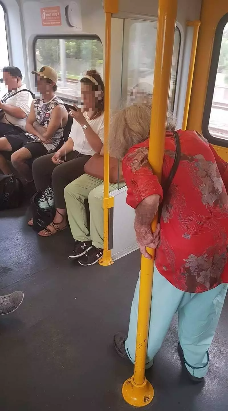 The four passengers appeared not to give up their seat for the elderly woman on the train.