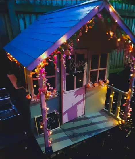 The house was draped with fairy lights (