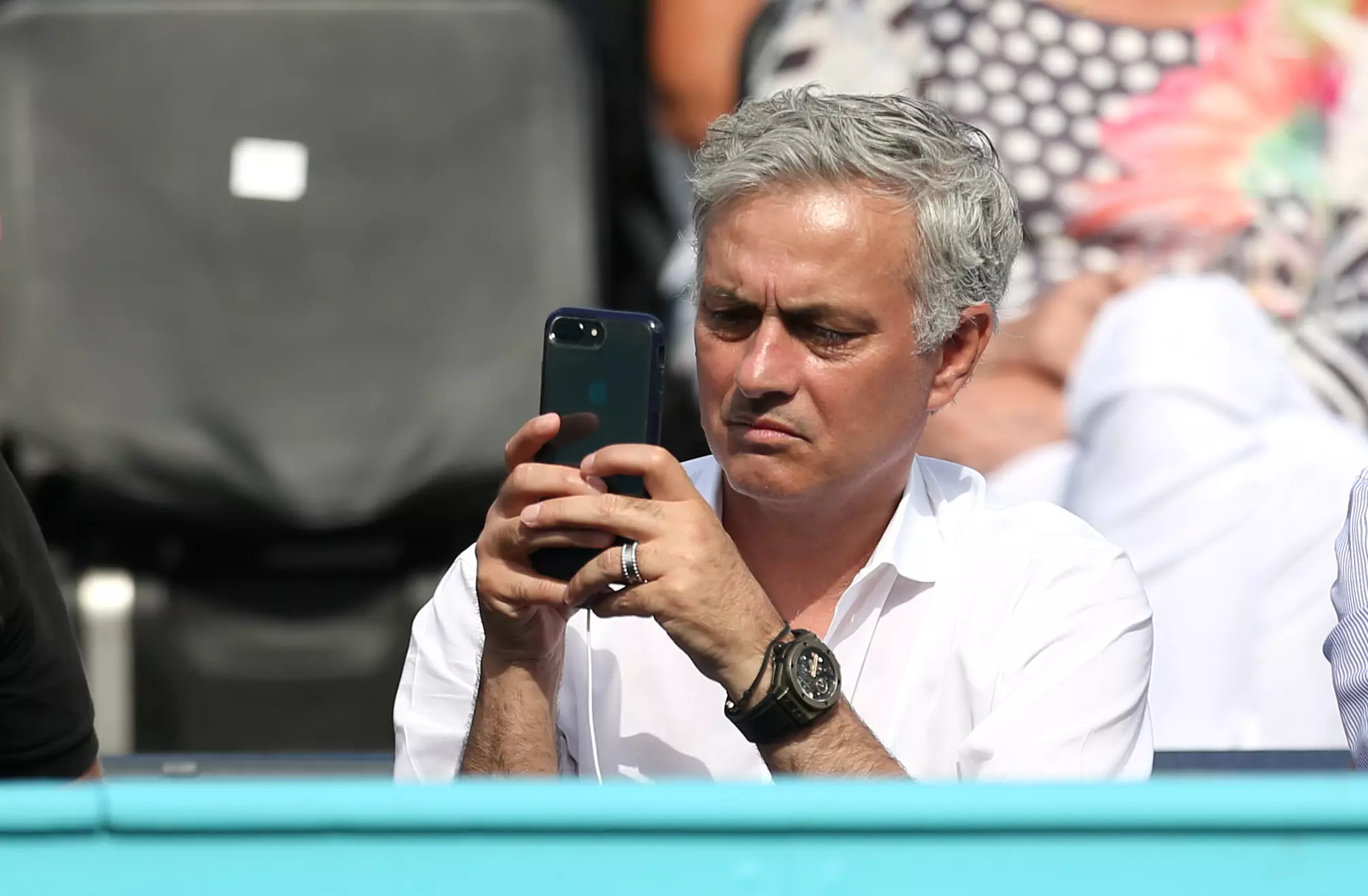Mourinho trying to work out Chinese on his phone. Image: PA Images
