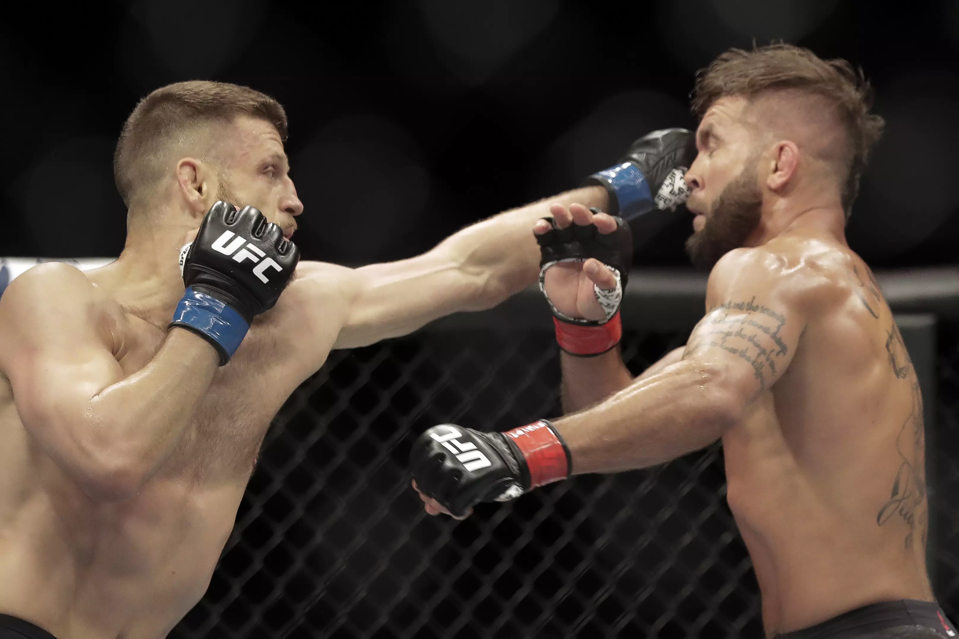 Calvin Kattar, left, strikes Jeremy Stephens, right, during their bout. (Image